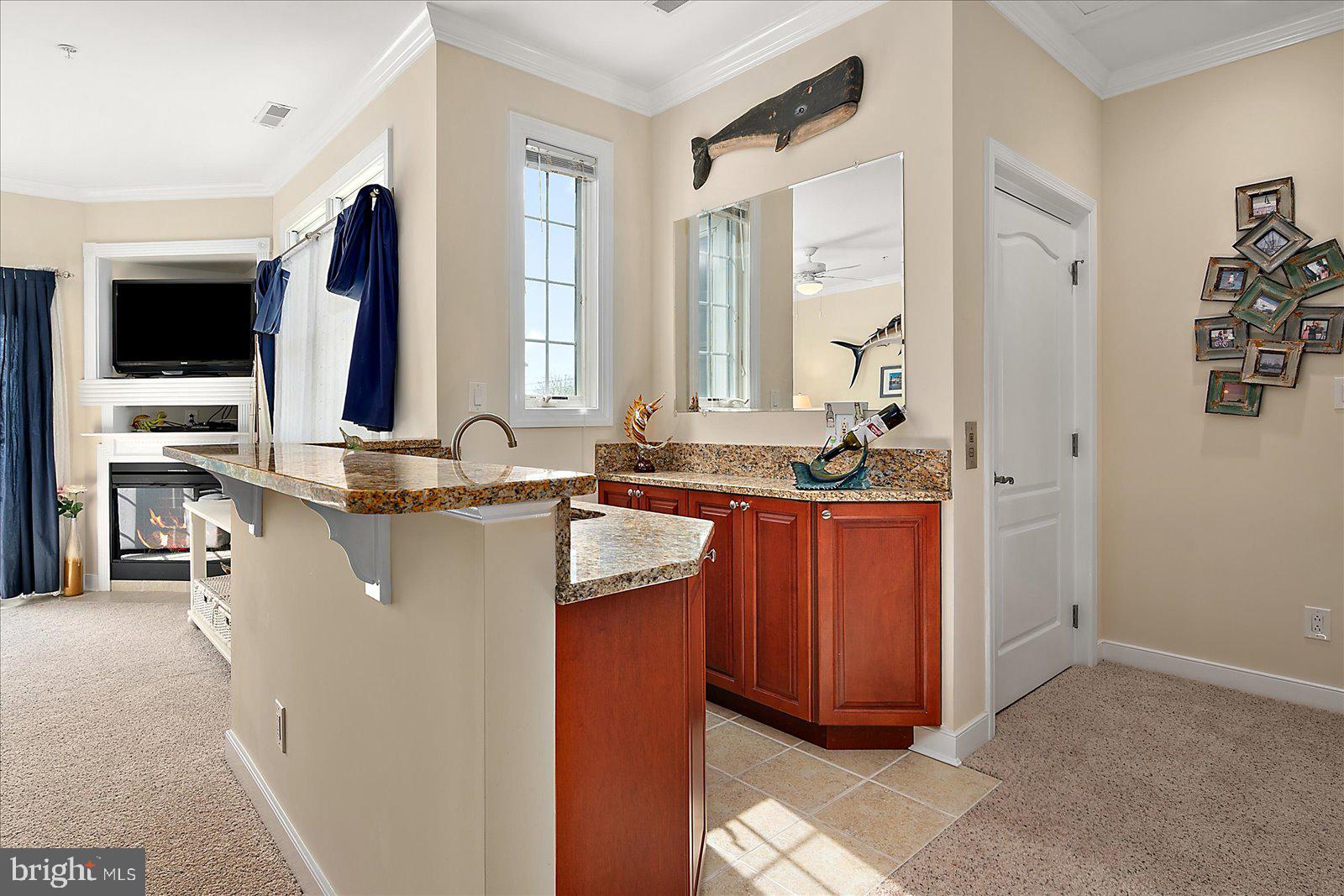 9823 Golf Course Road, Unit 7 Ocean City, MD 21842 - Photo 14 of 76 a bathroom with sink a mirror and vanity