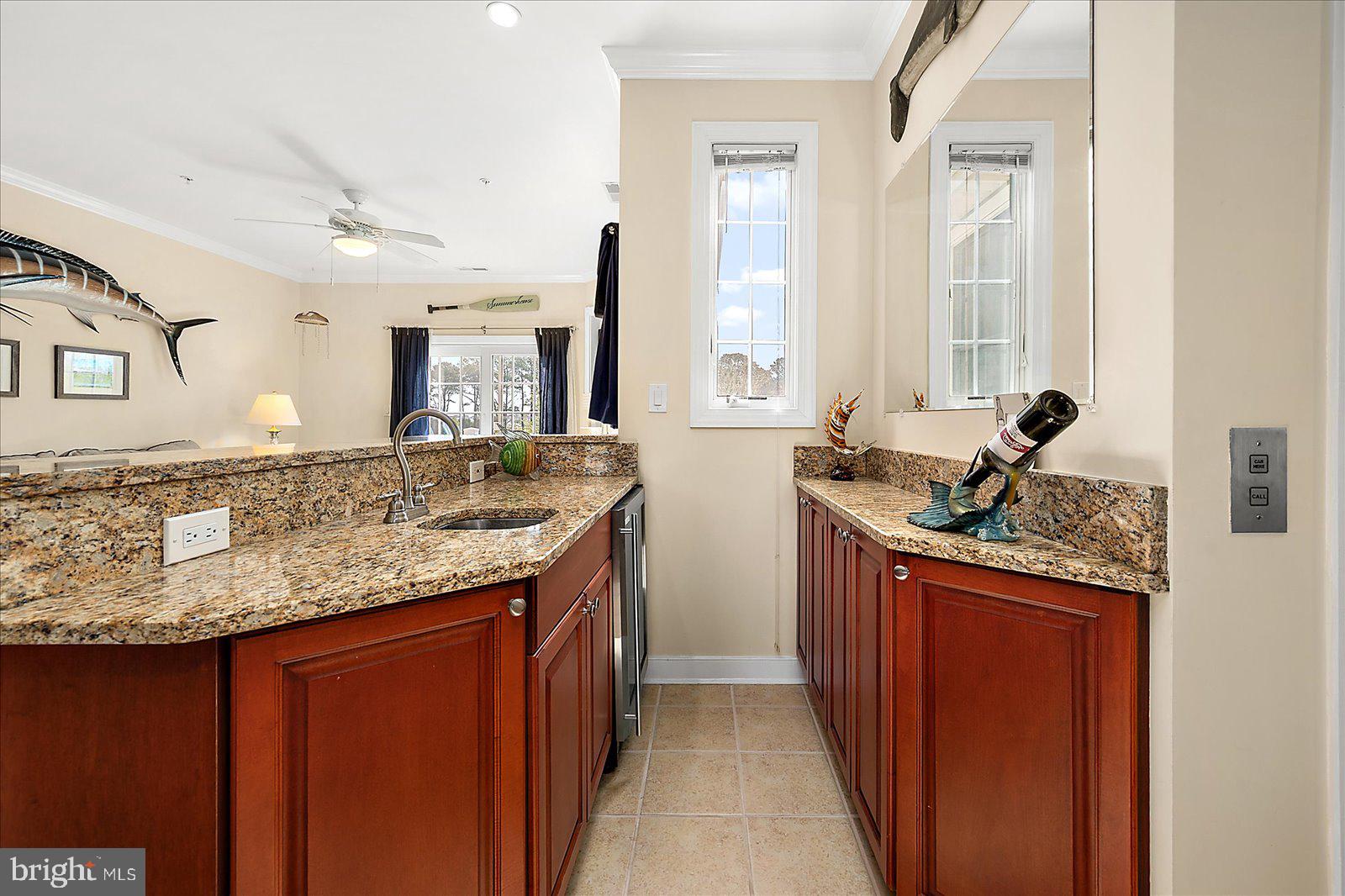 9823 Golf Course Road, Unit 7 Ocean City, MD 21842 - Photo 15 of 76 a bathroom with a granite countertop sink and a mirror