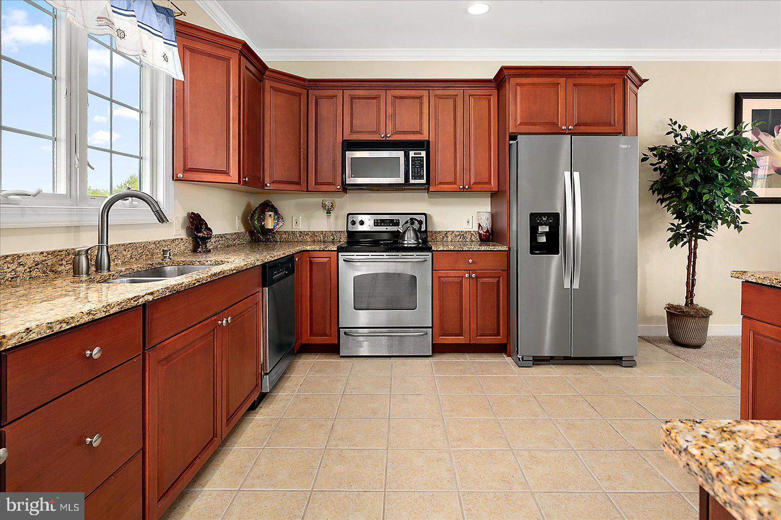 9823 Golf Course Road, Unit 7 Ocean City, MD 21842 - Photo 20 of 76 a kitchen with stainless steel appliances granite countertop a refrigerator a stove a sink and dishwasher