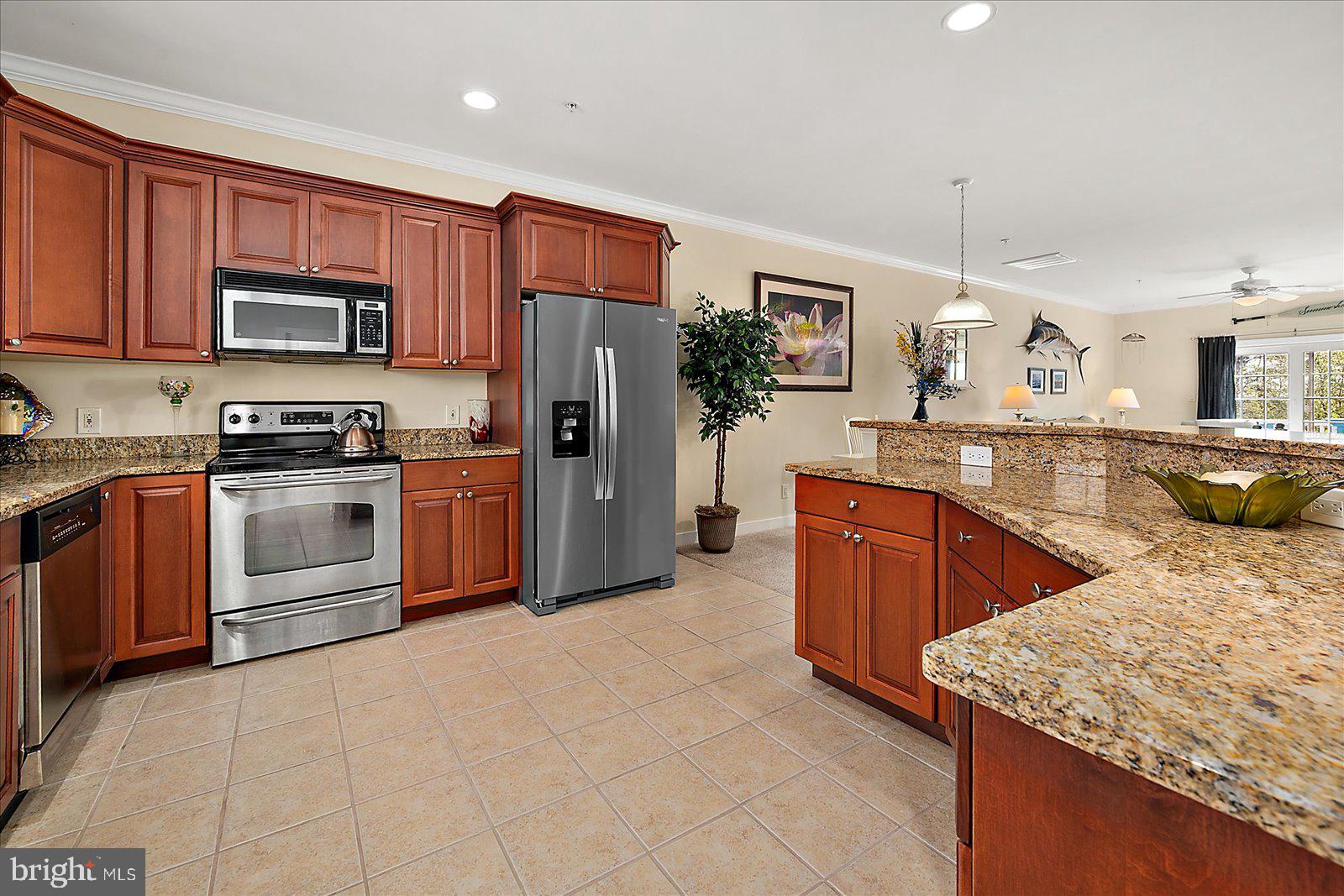 9823 Golf Course Road, Unit 7 Ocean City, MD 21842 - Photo 21 of 76 a kitchen with stainless steel appliances granite countertop a stove a sink dishwasher a refrigerator and a oven