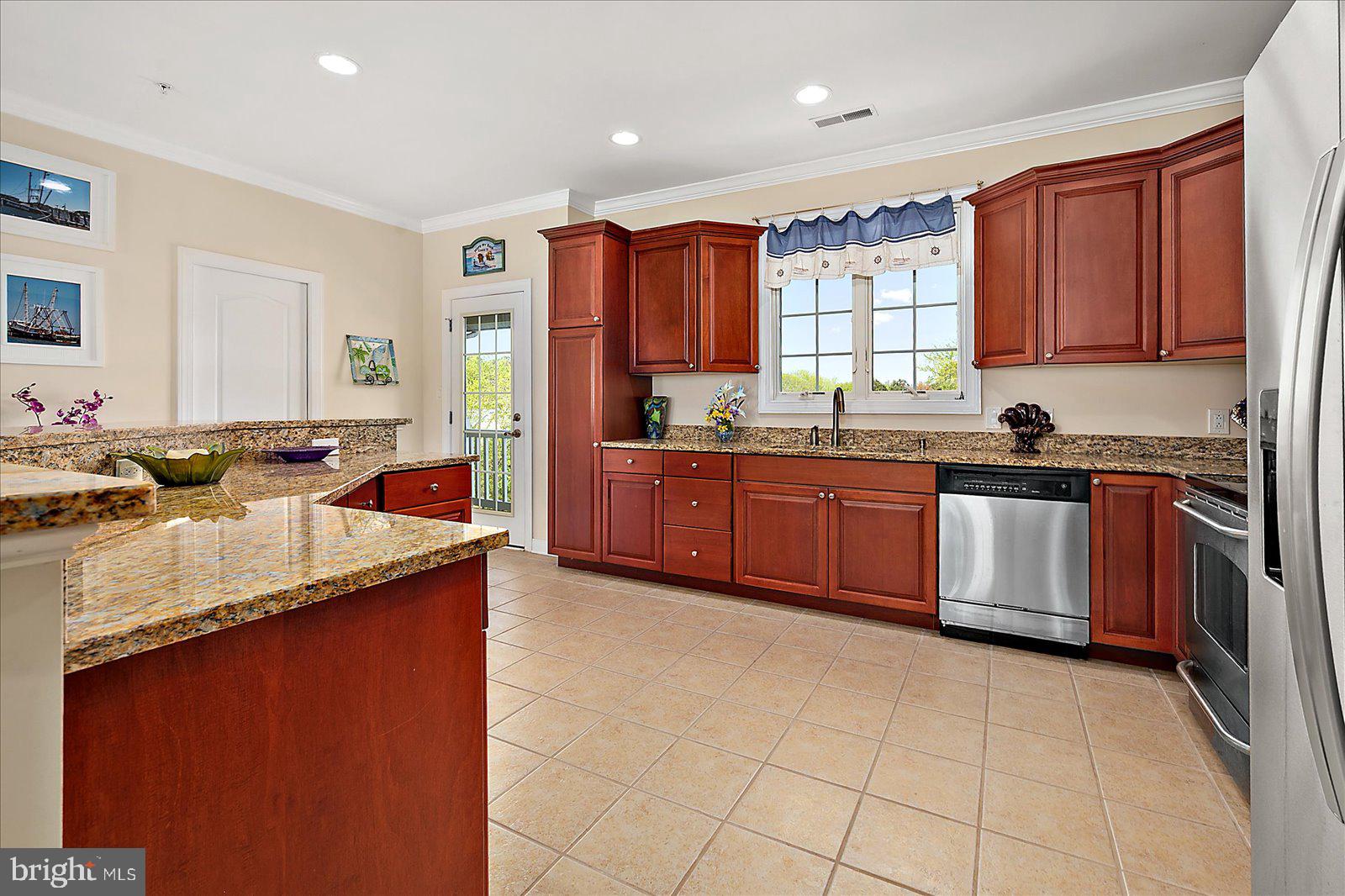 9823 Golf Course Road, Unit 7 Ocean City, MD 21842 - Photo 23 of 76 a kitchen with a sink stove top oven and cabinets