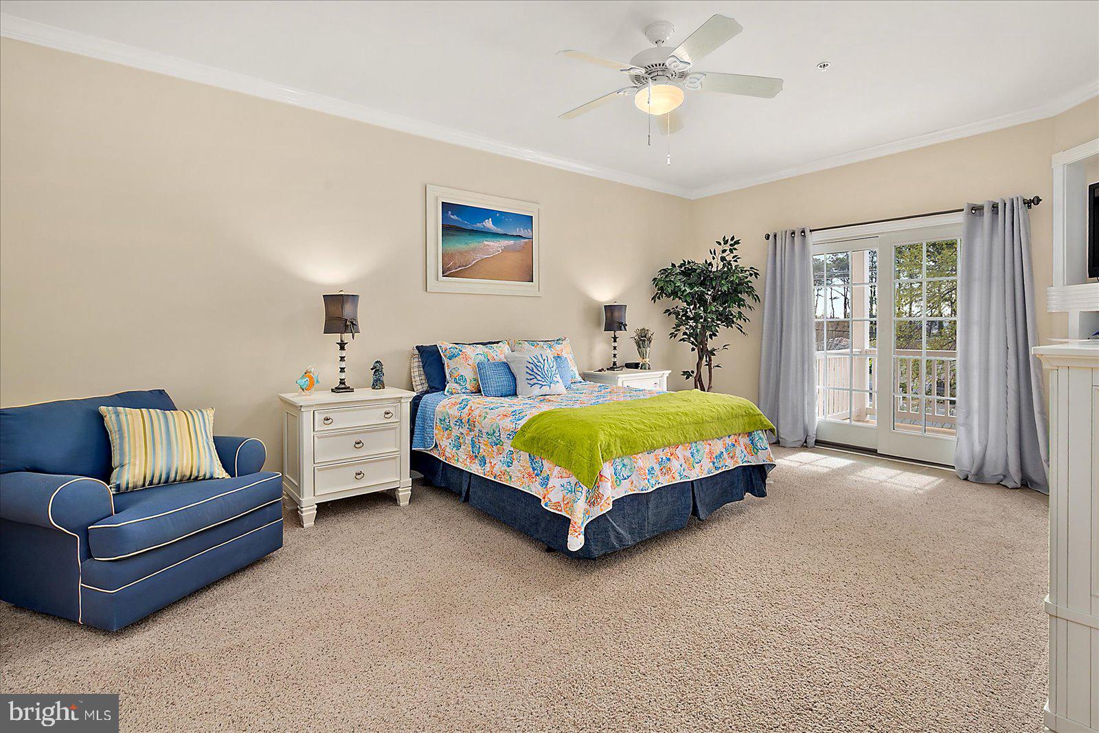 9823 Golf Course Road, Unit 7 Ocean City, MD 21842 - Photo 29 of 76 a bedroom with a bed couch chandelier and window