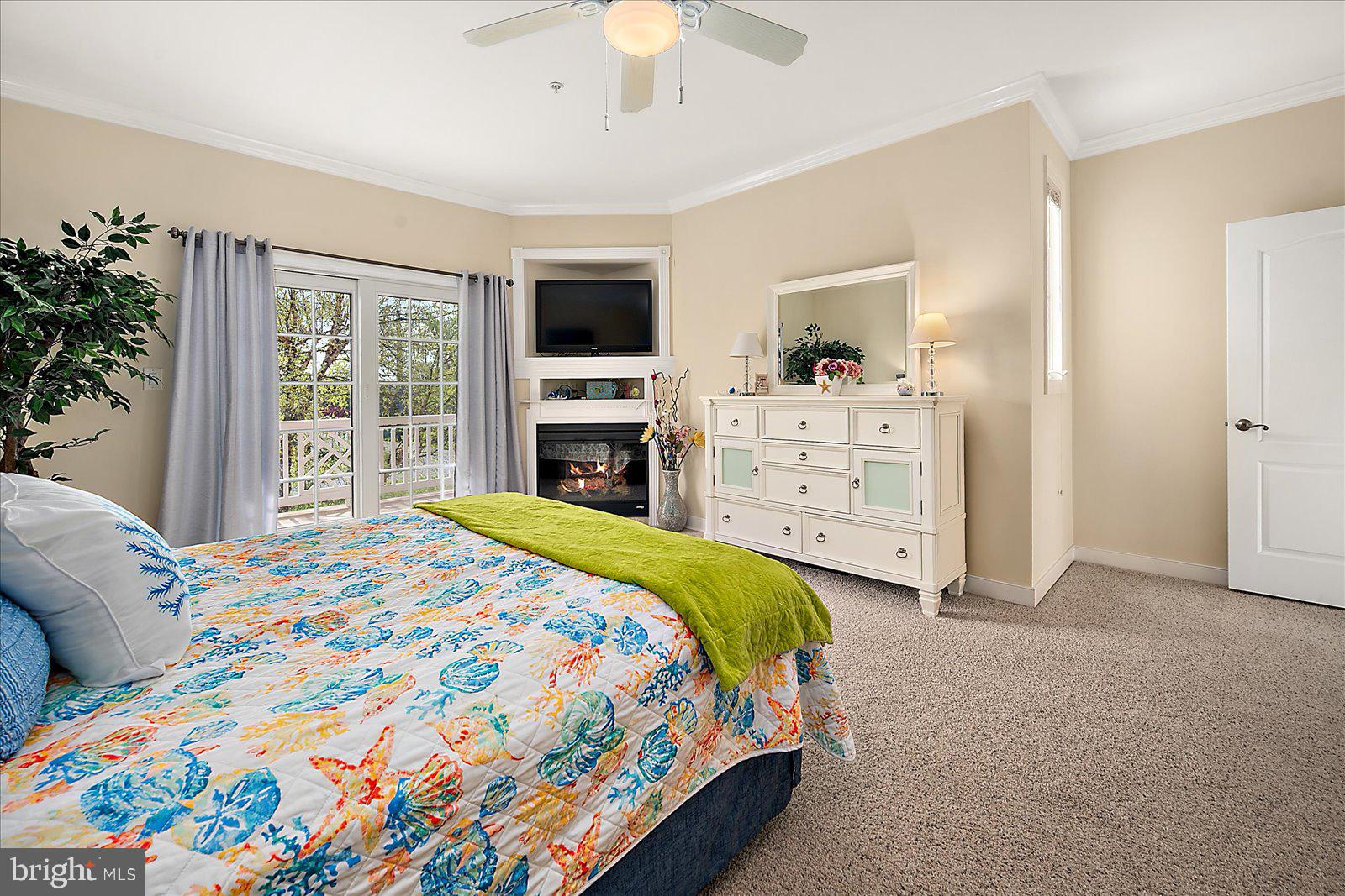 9823 Golf Course Road, Unit 7 Ocean City, MD 21842 - Photo 30 of 76 a bedroom with a bed and a flat screen tv