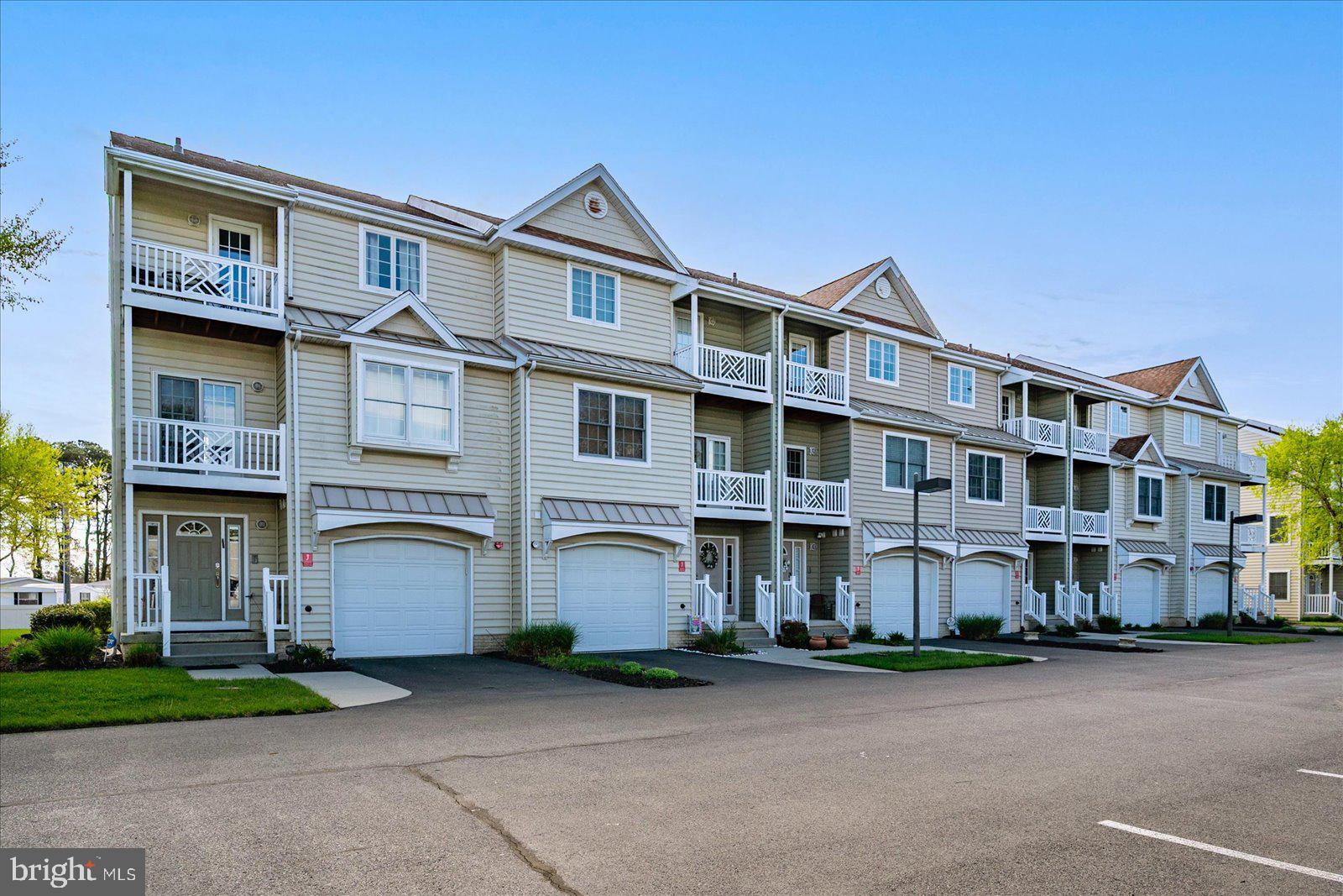 9823 Golf Course Road, Unit 7 Ocean City, MD 21842 - Photo 3 of 76 a front view of a multi story building