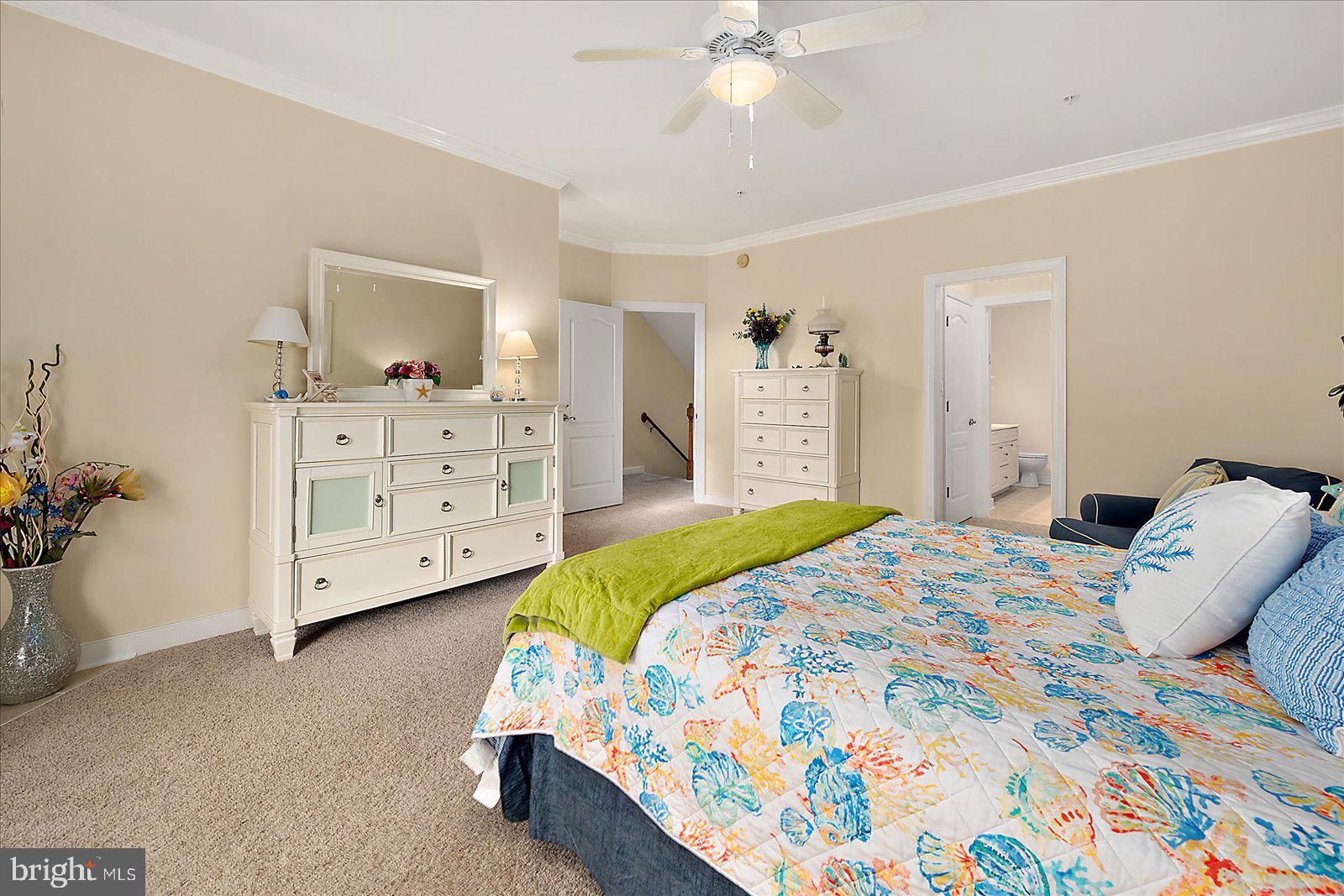 9823 Golf Course Road, Unit 7 Ocean City, MD 21842 - Photo 31 of 76 a bedroom with a bed and a chandelier