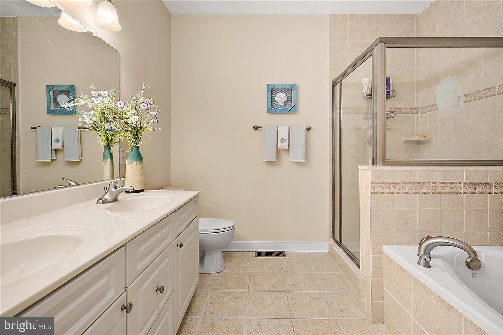 9823 Golf Course Road, Unit 7 Ocean City, MD 21842 - Photo 33 of 76 a bathroom with a granite countertop sink a toilet and mirror