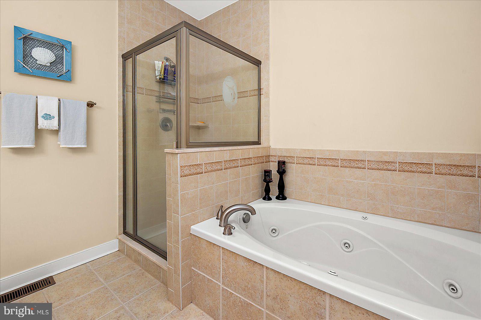 9823 Golf Course Road, Unit 7 Ocean City, MD 21842 - Photo 36 of 76 a bathroom with a tub and shower
