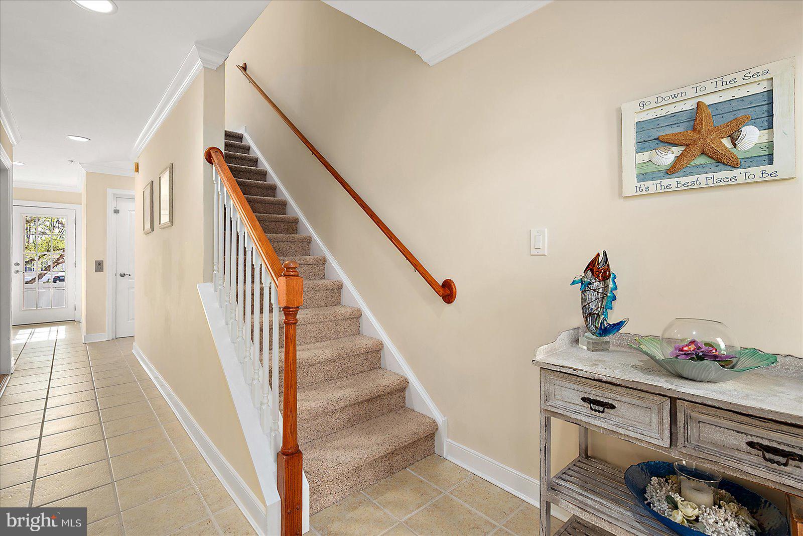 9823 Golf Course Road, Unit 7 Ocean City, MD 21842 - Photo 37 of 76 a view of hallway with furniture and stairs