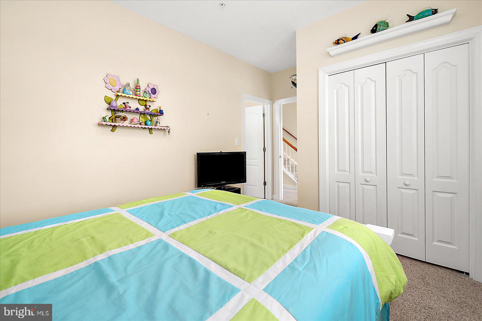 9823 Golf Course Road, Unit 7 Ocean City, MD 21842 - Photo 45 of 76 a bedroom with a bed and a table