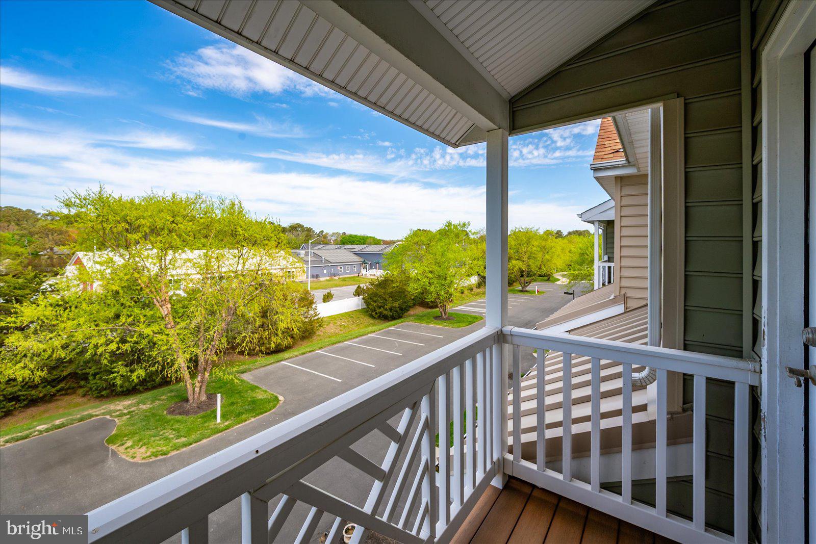 9823 Golf Course Road, Unit 7 Ocean City, MD 21842 - Photo 49 of 76 a view of a balcony with floor to ceiling windows with wooden floor