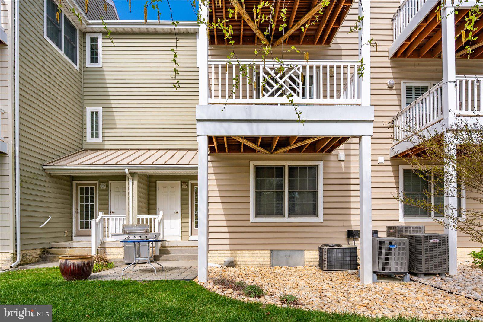 9823 Golf Course Road, Unit 7 Ocean City, MD 21842 - Photo 5 of 76 a front view of a house with a yard and outdoor seating