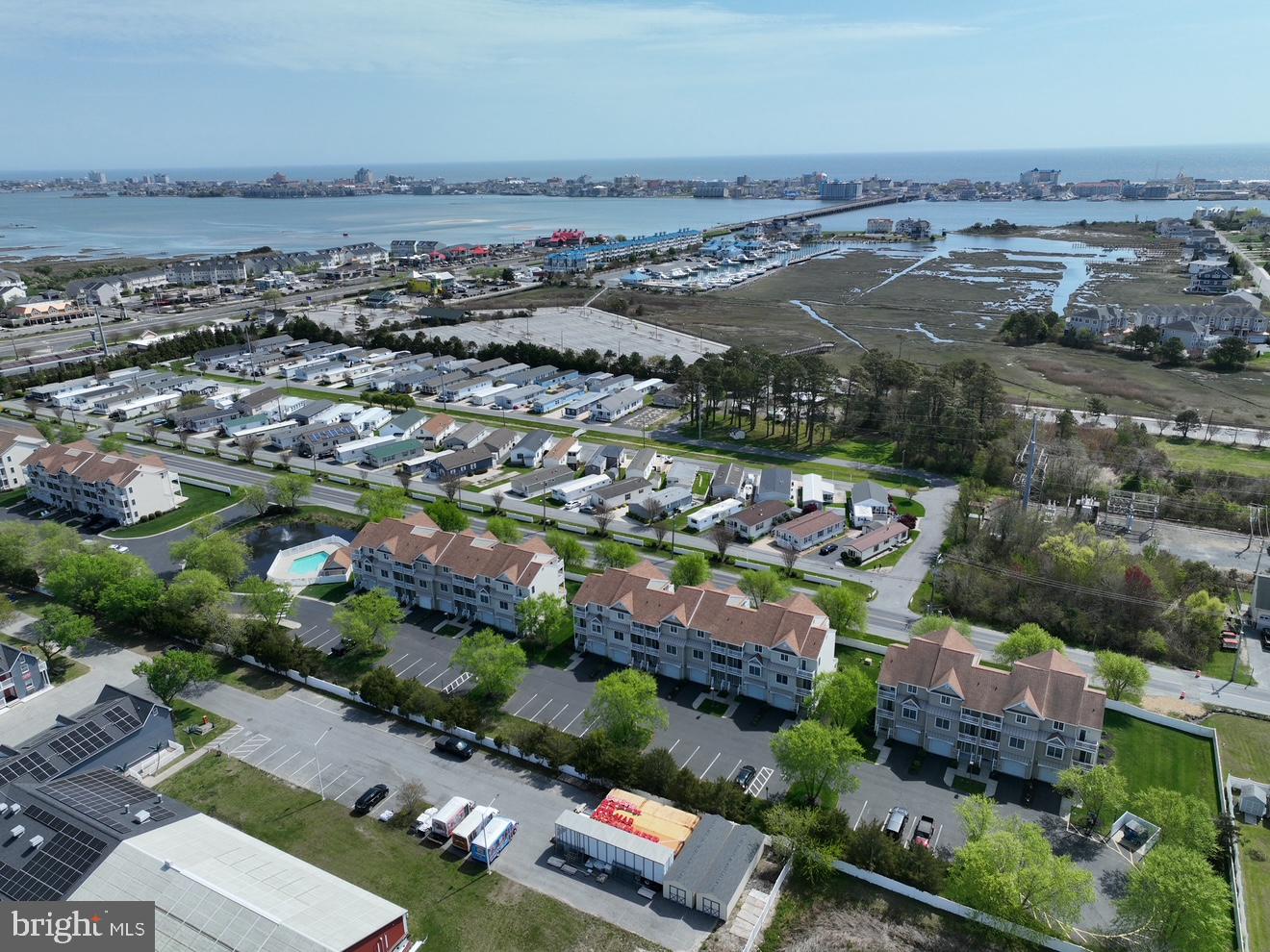 9823 Golf Course Road, Unit 7 Ocean City, MD 21842 - Photo 65 of 76 an aerial view of a city with lots of residential buildings and mountain view in back