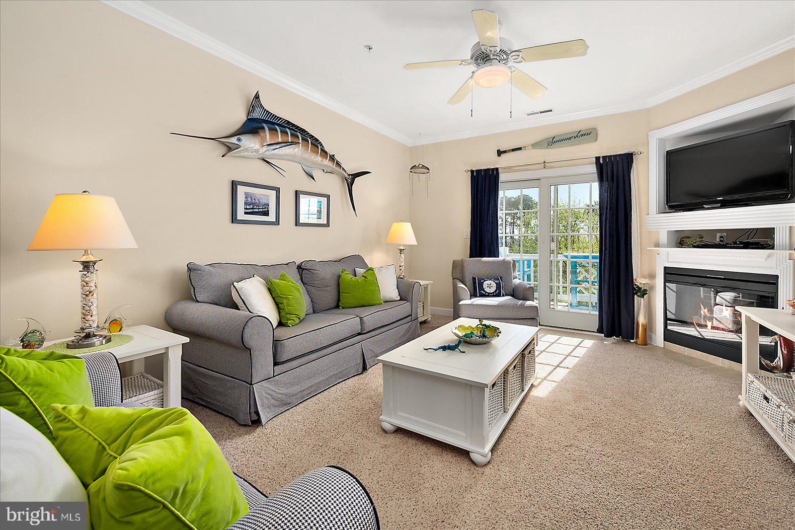 9823 Golf Course Road, Unit 7 Ocean City, MD 21842 - Photo 7 of 76 a living room with furniture and a flat screen tv