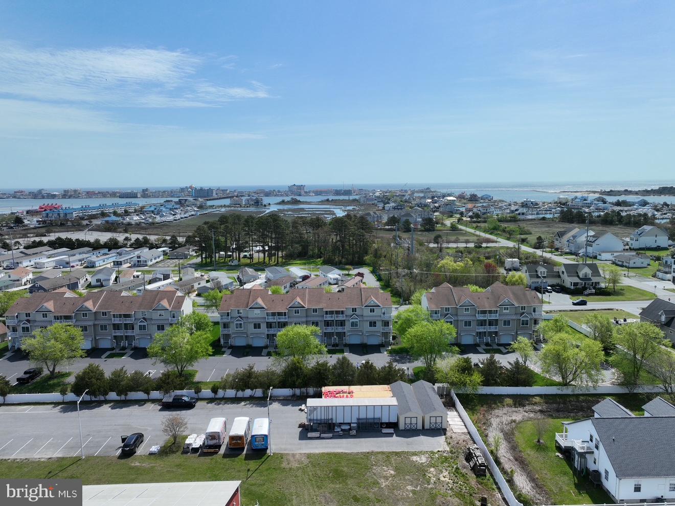 9823 Golf Course Road, Unit 7 Ocean City, MD 21842 - Photo 70 of 76 an aerial view of house with yard swimming pool and ocean view