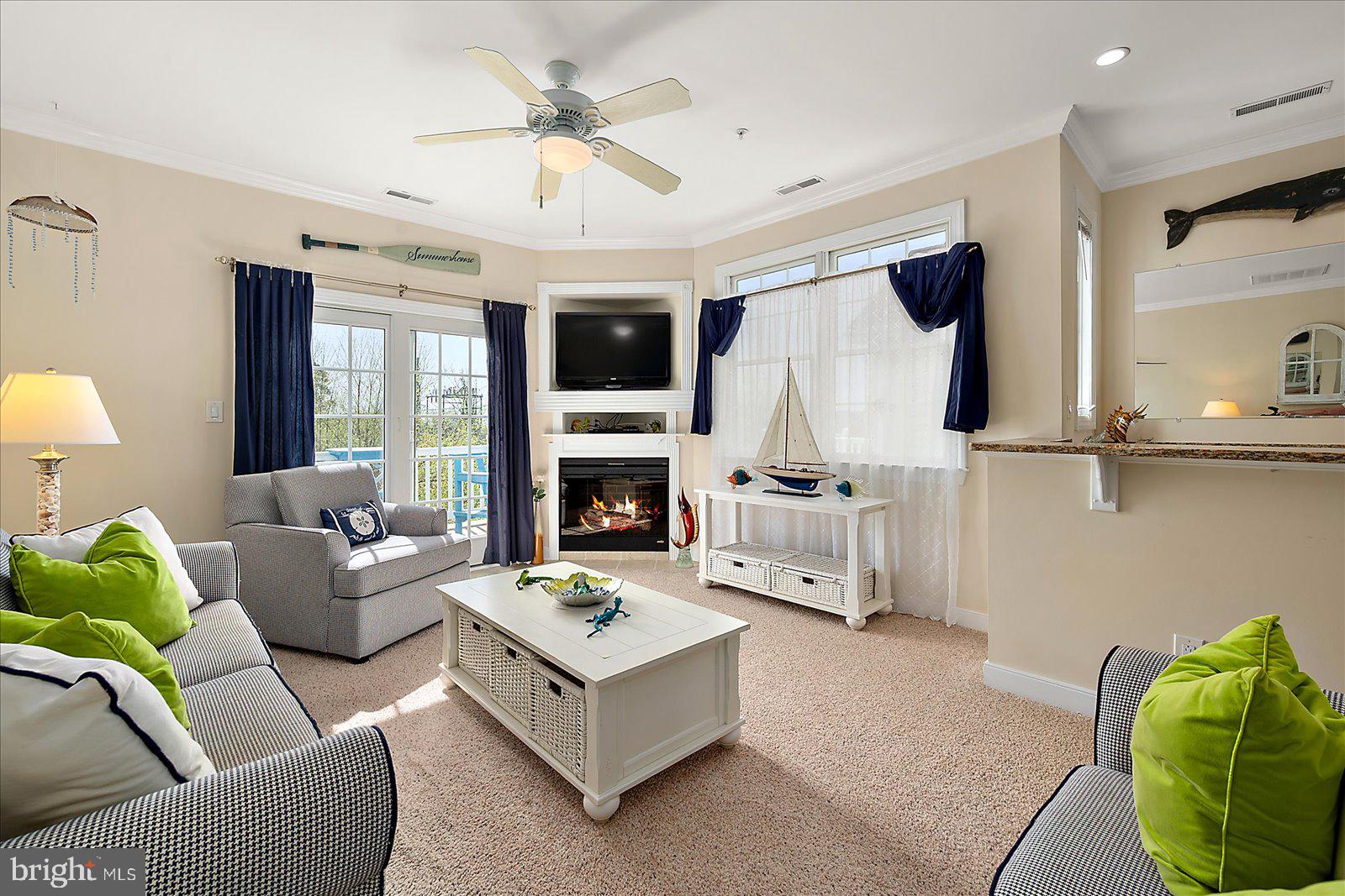 9823 Golf Course Road, Unit 7 Ocean City, MD 21842 - Photo 9 of 76 a living room with furniture and a fireplace