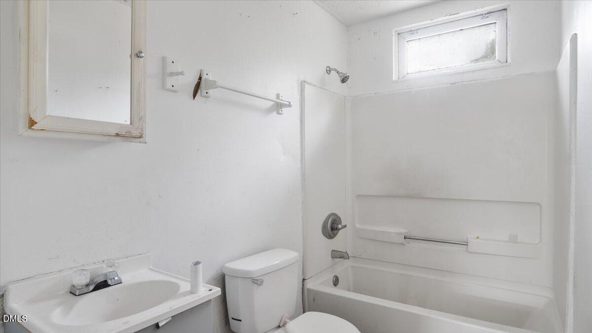 119 Fox Pond Road Henderson, NC 27537 - Photo 14 of 34 a bathroom with a sink toilet and shower