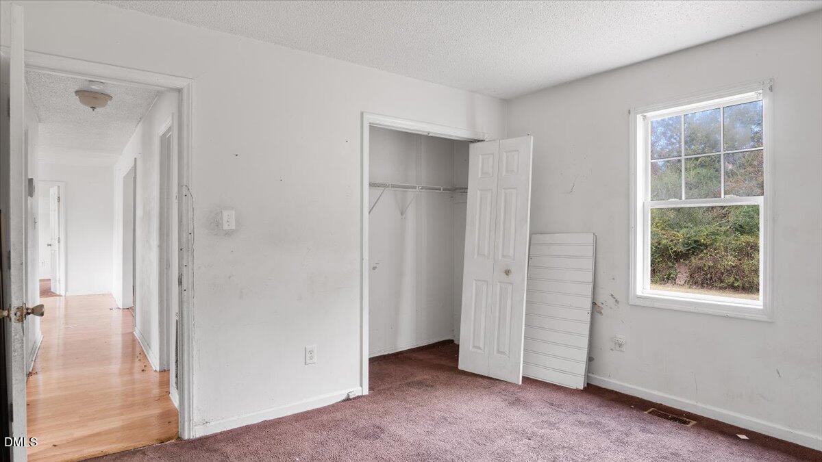 119 Fox Pond Road Henderson, NC 27537 - Photo 16 of 34 an empty room with windows and closet
