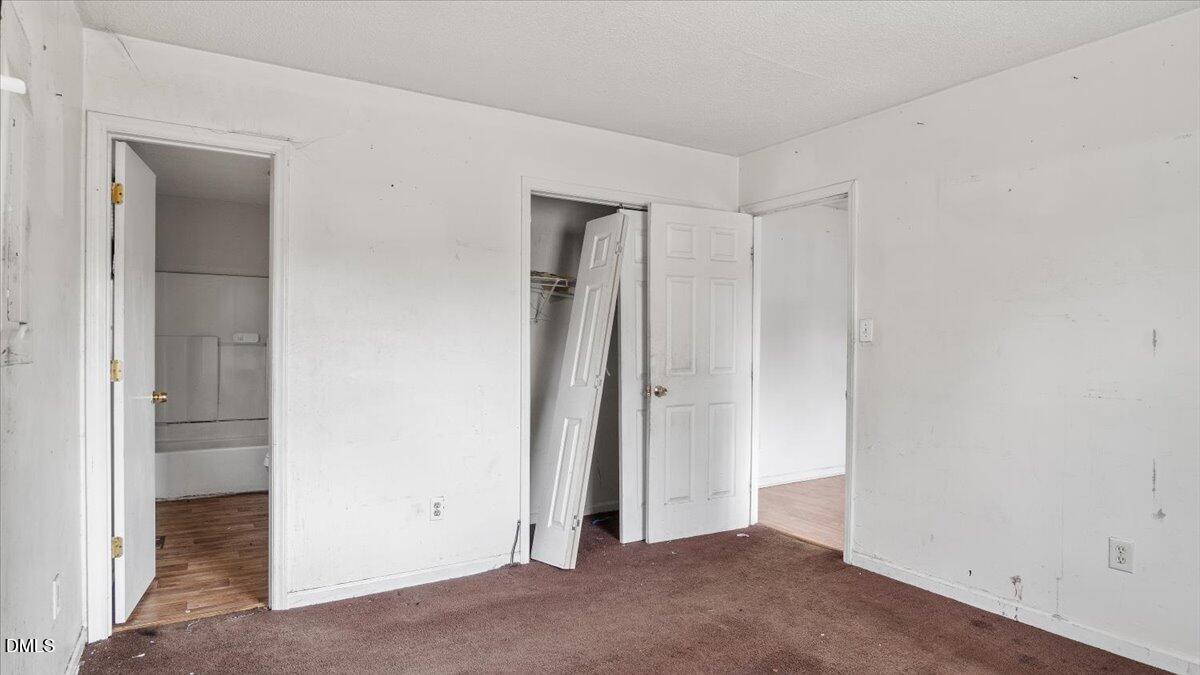 119 Fox Pond Road Henderson, NC 27537 - Photo 21 of 34 an empty room with closet and a bathroom