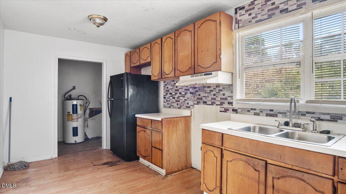 119 Fox Pond Road Henderson, NC 27537 - Photo 8 of 34 a kitchen with stainless steel appliances granite countertop a sink stove and refrigerator