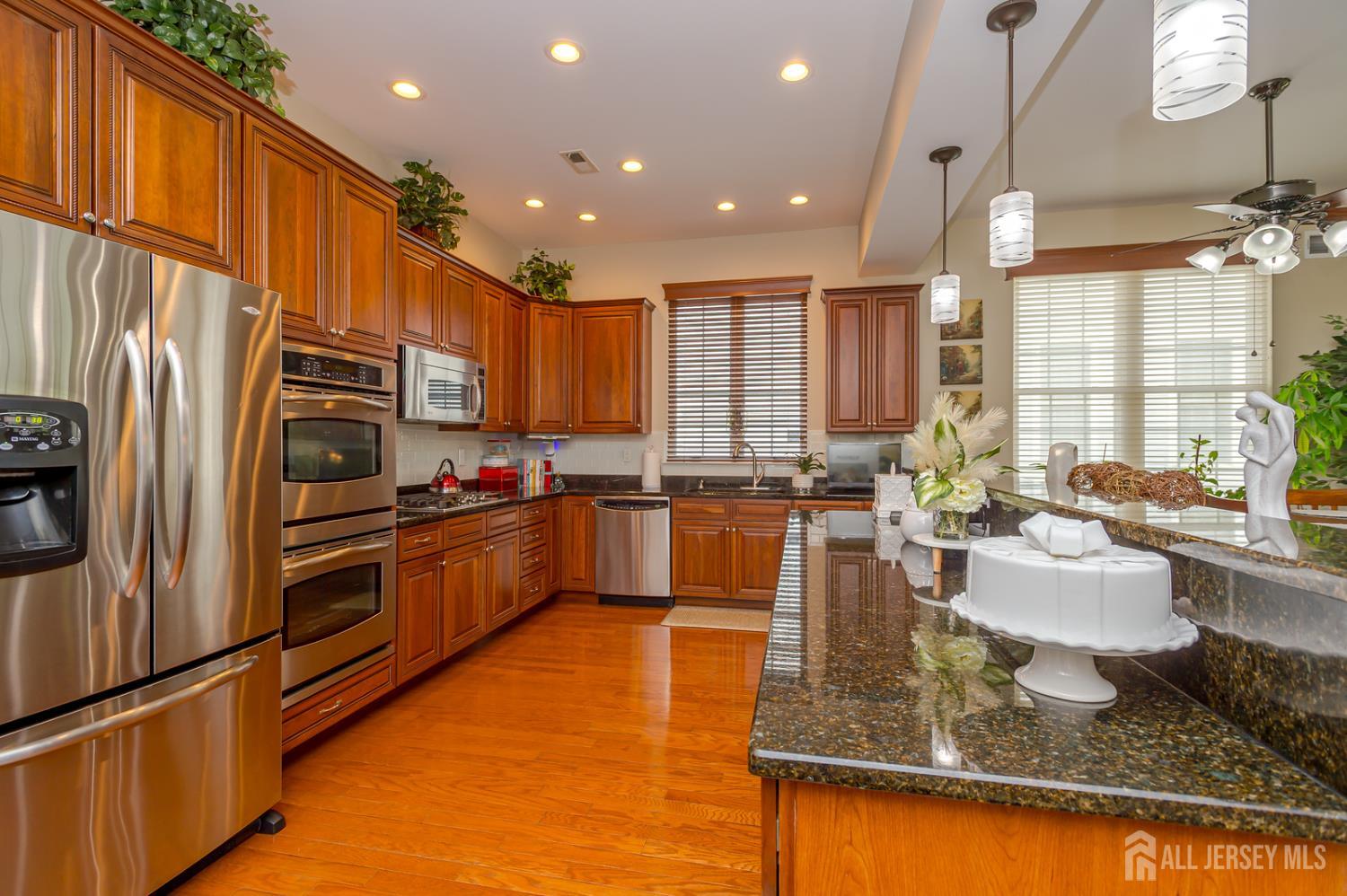 44 Kings Mill Road Monroe Township, NJ 08831 - Photo 12 of 38 a kitchen with stainless steel appliances granite countertop a refrigerator sink and stove