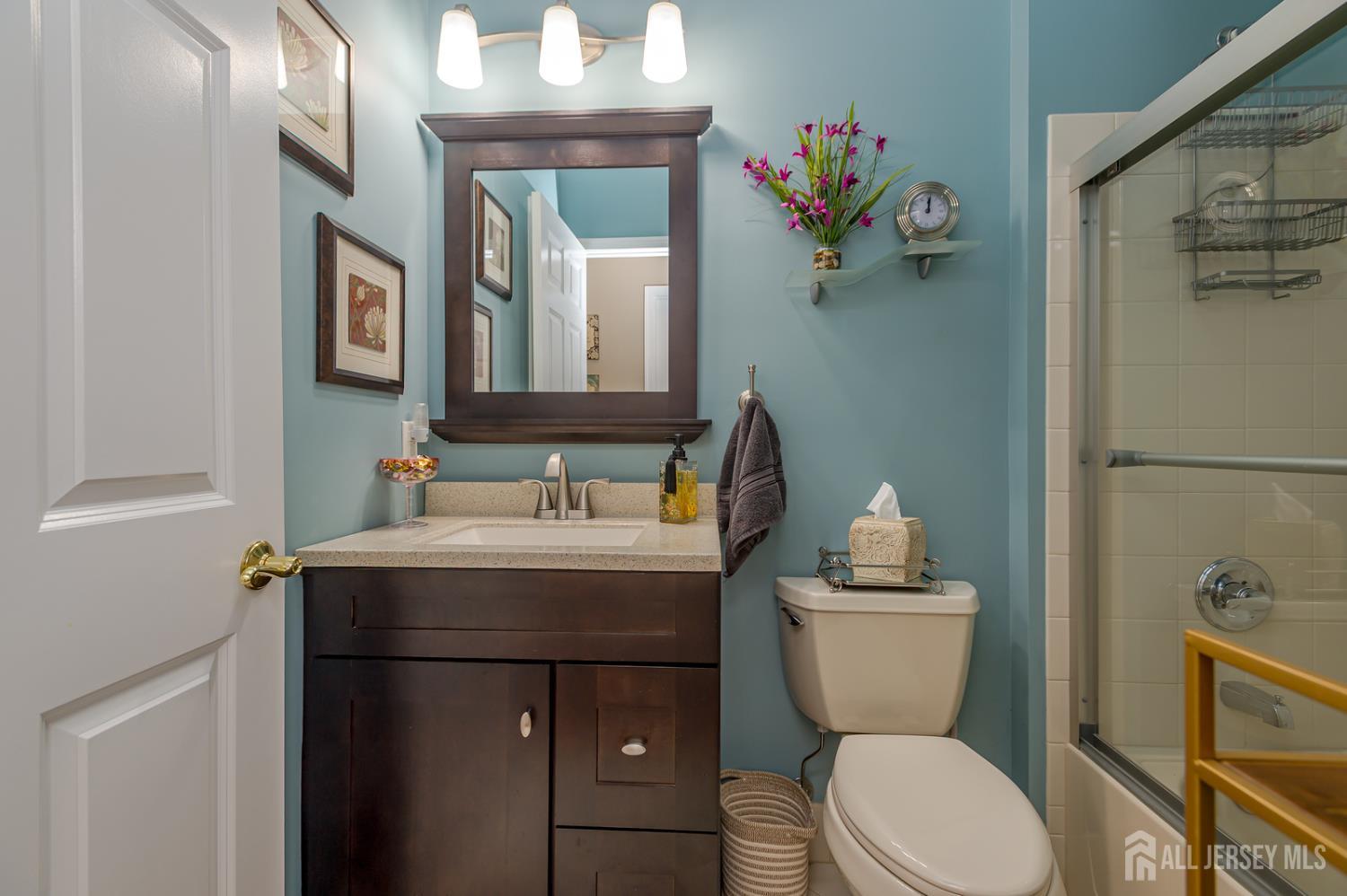 44 Kings Mill Road Monroe Township, NJ 08831 - Photo 19 of 38 a bathroom with a sink a toilet and a mirror
