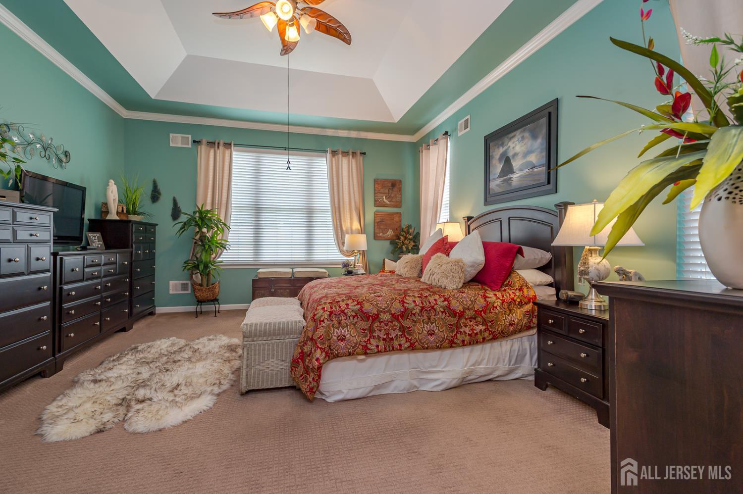 44 Kings Mill Road Monroe Township, NJ 08831 - Photo 23 of 38 a bedroom with a bed and a chandelier