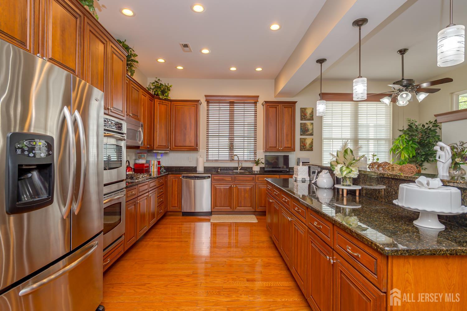 44 Kings Mill Road Monroe Township, NJ 08831 - Photo 9 of 38 a large kitchen with stainless steel appliances lots of counter space and a sink