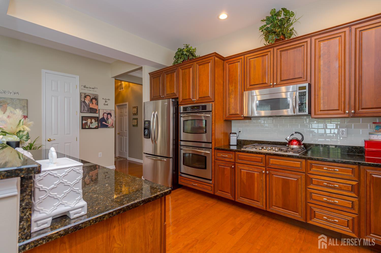 44 Kings Mill Road Monroe Township, NJ 08831 - Photo 10 of 38 a kitchen with stainless steel appliances granite countertop a refrigerator and a stove top oven
