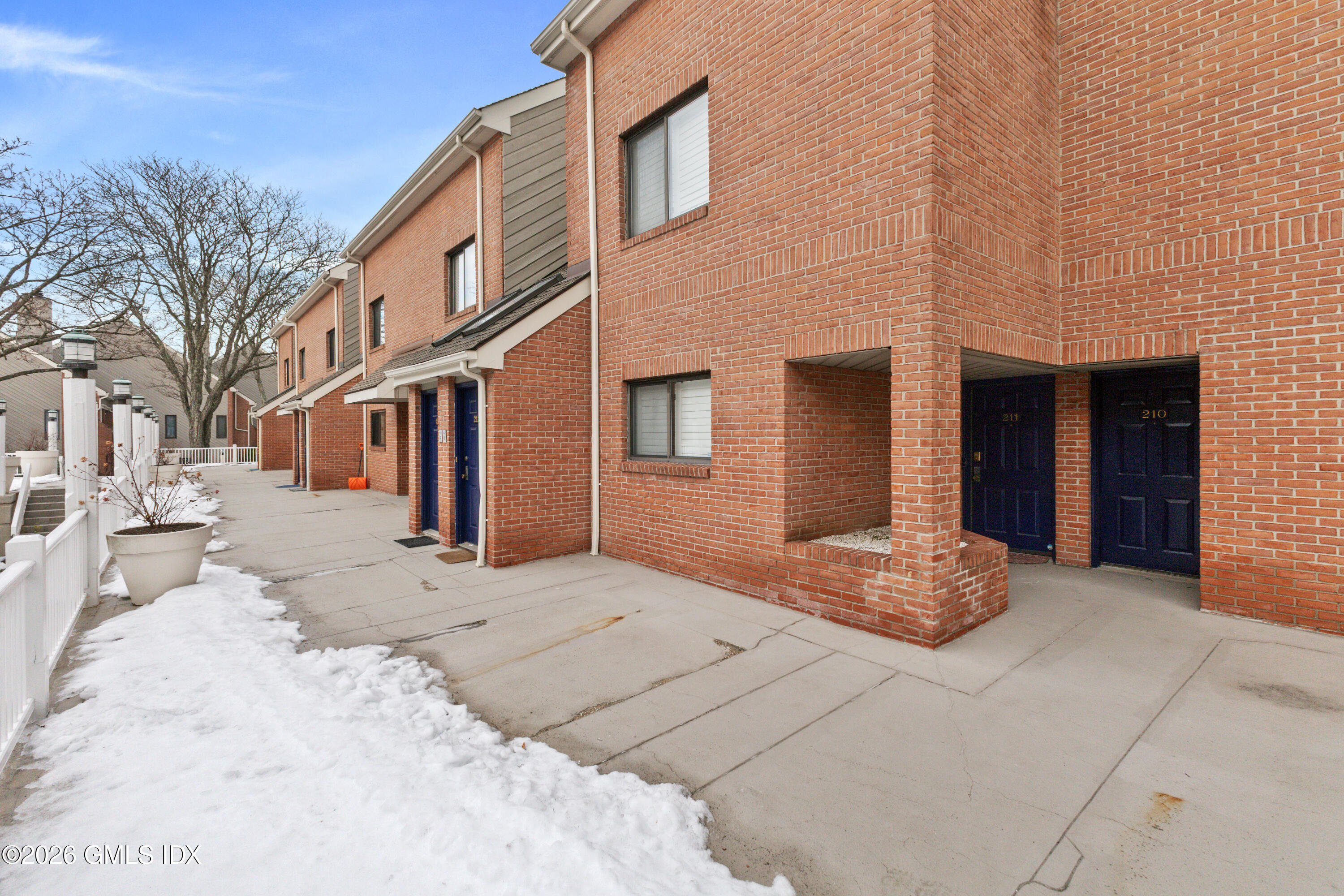 15 River Road, Unit 210 Cos Cob, CT 06807 - Photo 23 of 23 a view of a house with a snow on the road