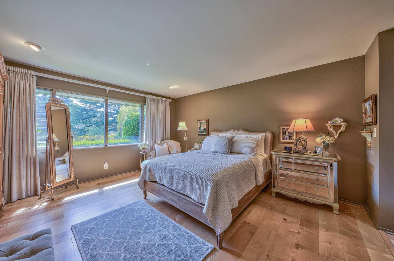 105 Del Mesa Carmel Carmel, CA 93923 - Photo 21 of 35 a bedroom with a large bed and a large window