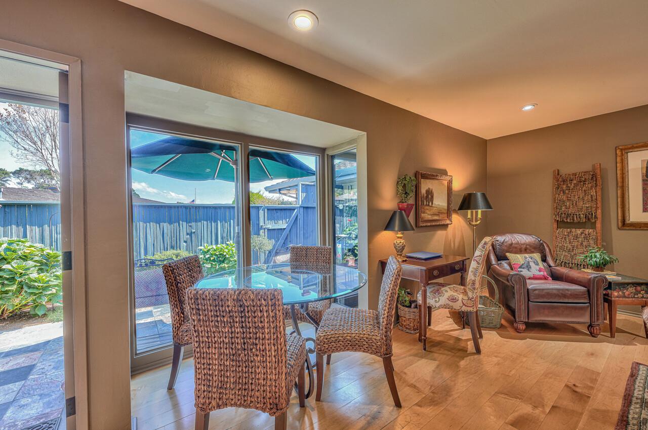 105 Del Mesa Carmel Carmel, CA 93923 - Photo 7 of 35 a dining room with furniture a fireplace and wooden floor