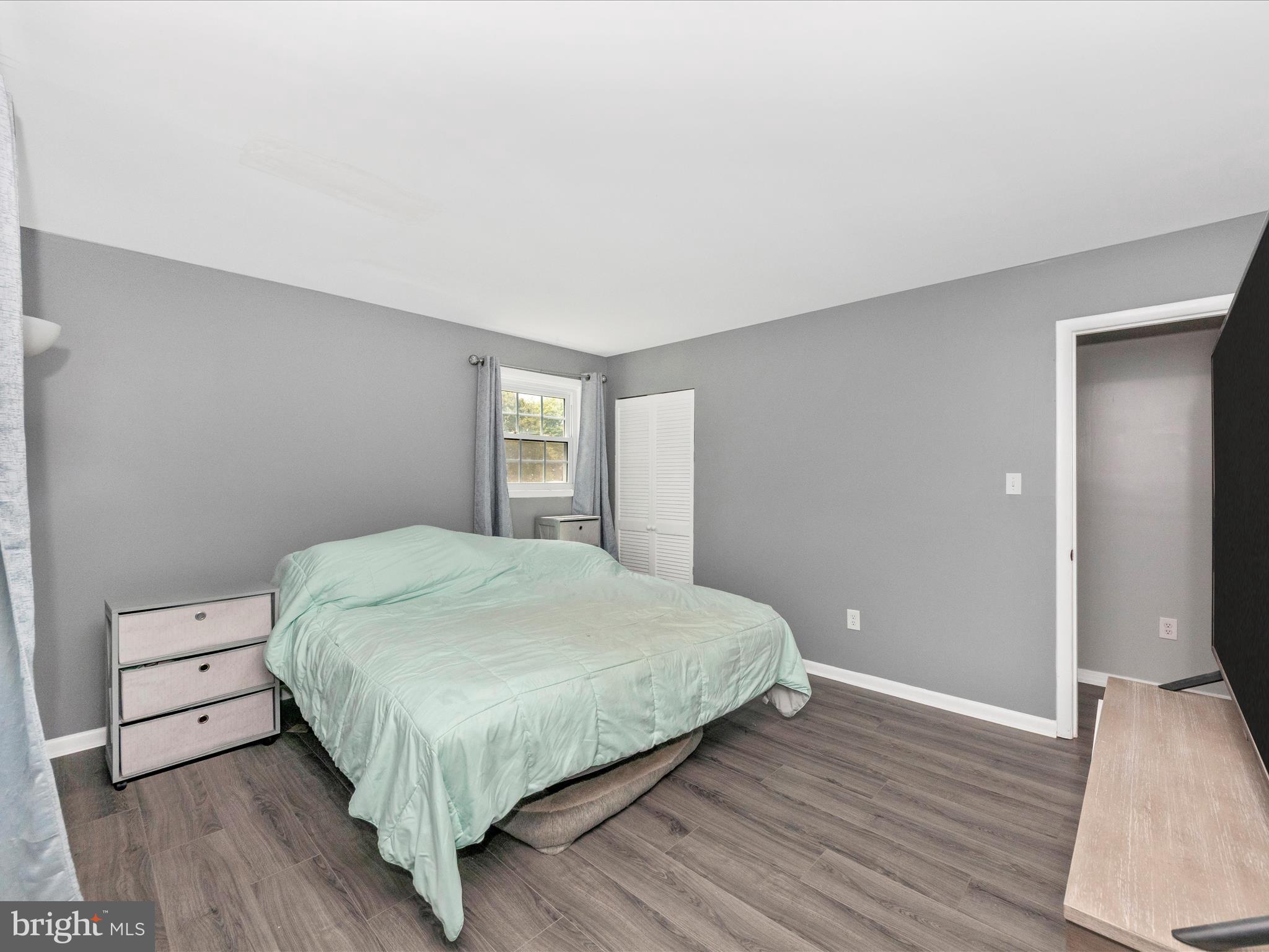 6503 Walker Branch Drive Laurel, MD 20707 - Photo 14 of 36 a bedroom with a bed and wooden floor