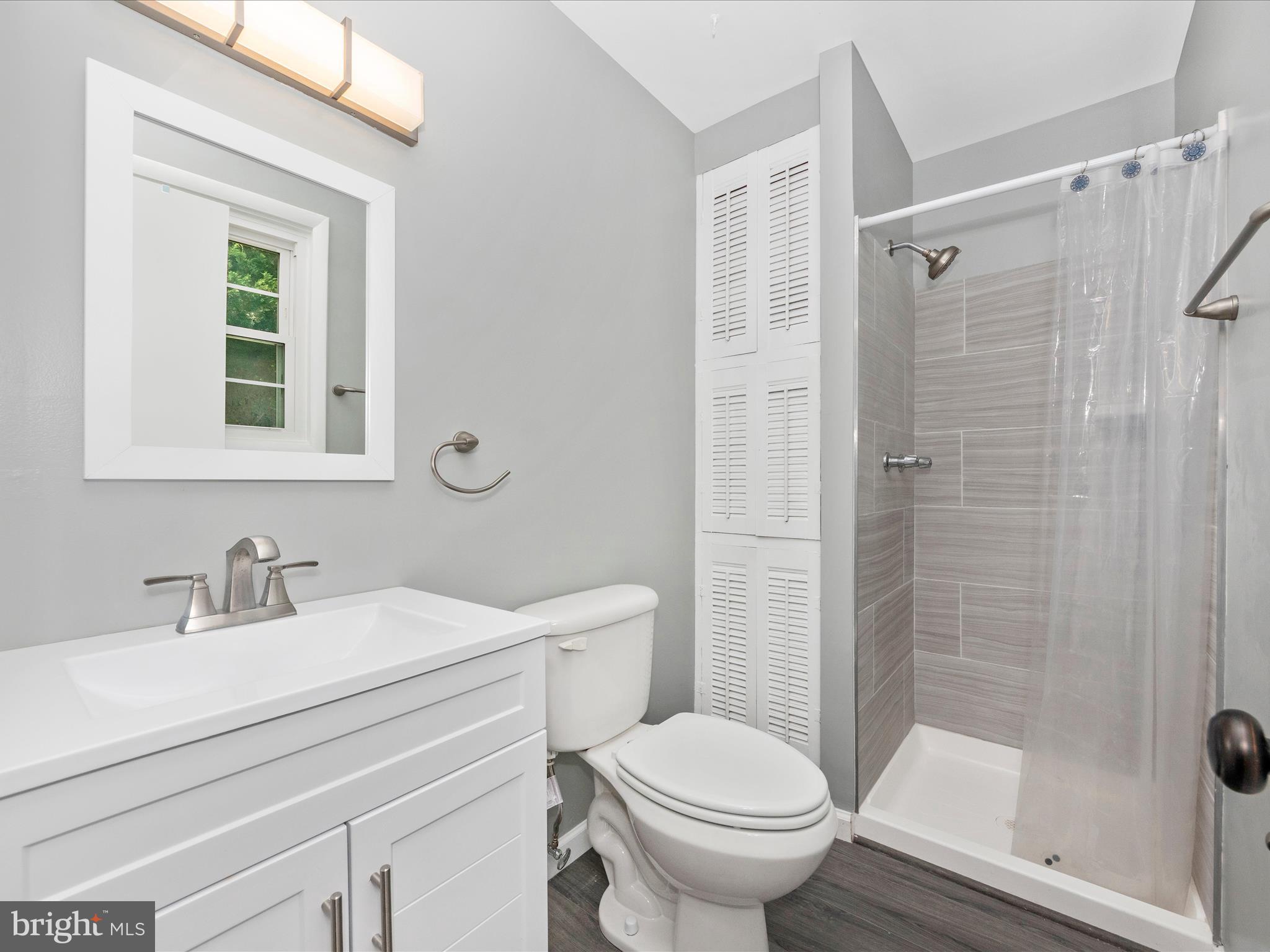 6503 Walker Branch Drive Laurel, MD 20707 - Photo 16 of 36 a bathroom with a sink toilet and shower