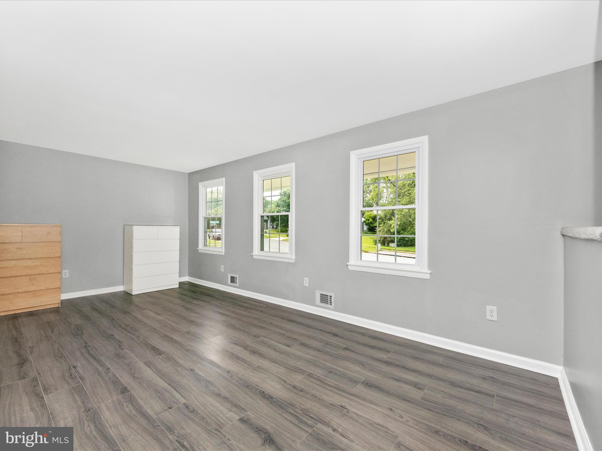 6503 Walker Branch Drive Laurel, MD 20707 - Photo 17 of 36 an empty room with wooden floor and windows
