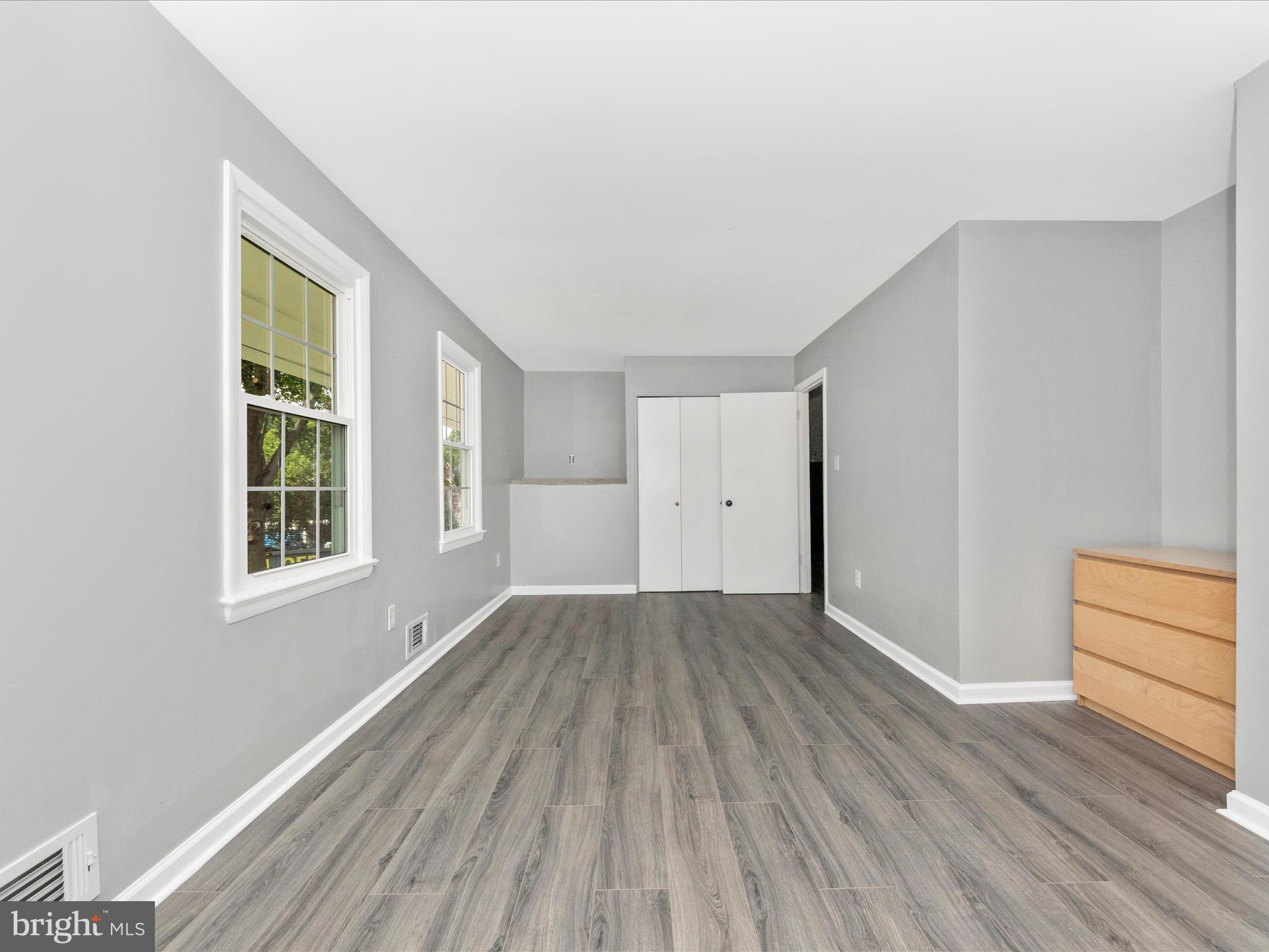 6503 Walker Branch Drive Laurel, MD 20707 - Photo 19 of 36 an empty room with wooden floor and windows