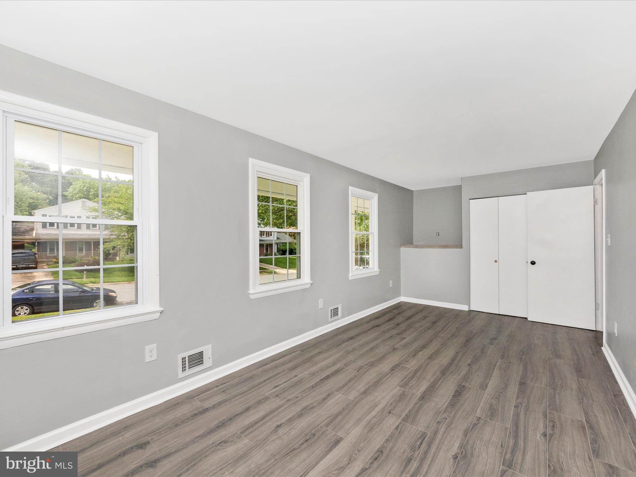 6503 Walker Branch Drive Laurel, MD 20707 - Photo 20 of 36 an empty room with wooden floor and windows