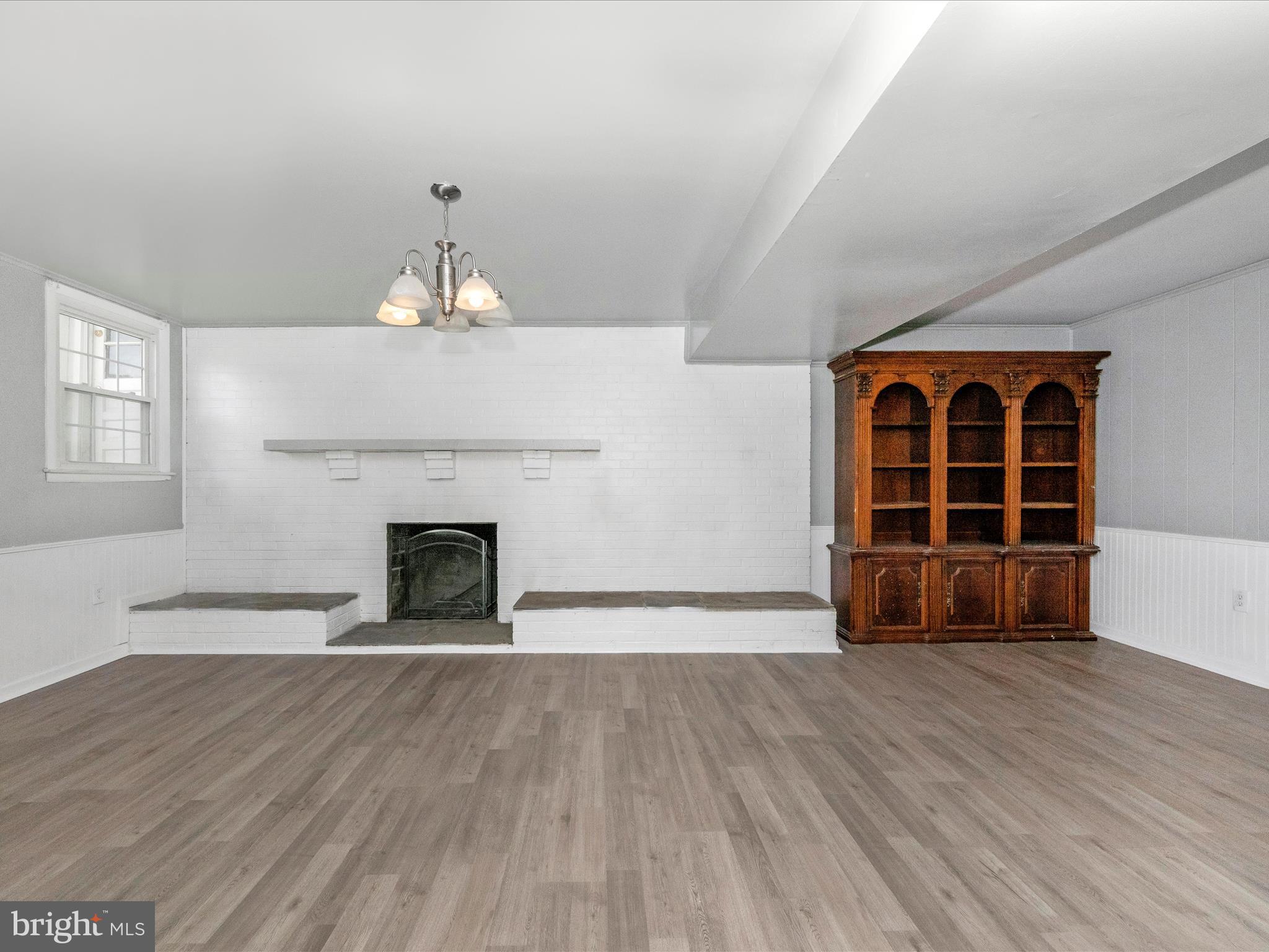 6503 Walker Branch Drive Laurel, MD 20707 - Photo 22 of 36 wooden floor fireplace and windows in an empty room