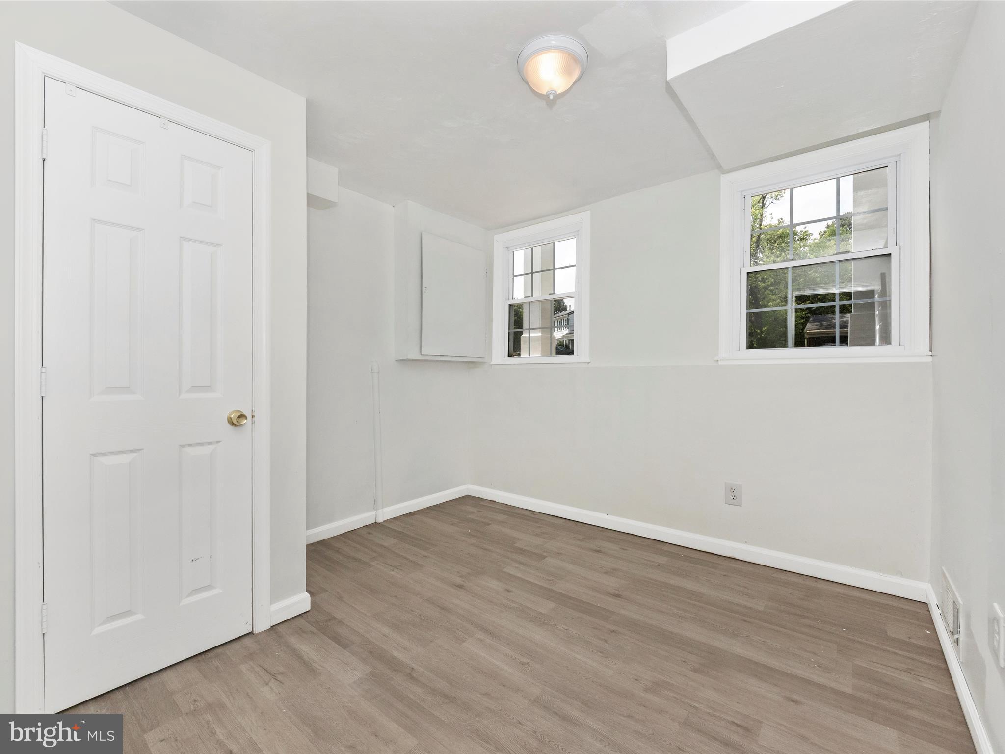 6503 Walker Branch Drive Laurel, MD 20707 - Photo 28 of 36 an empty room with wooden floor and windows