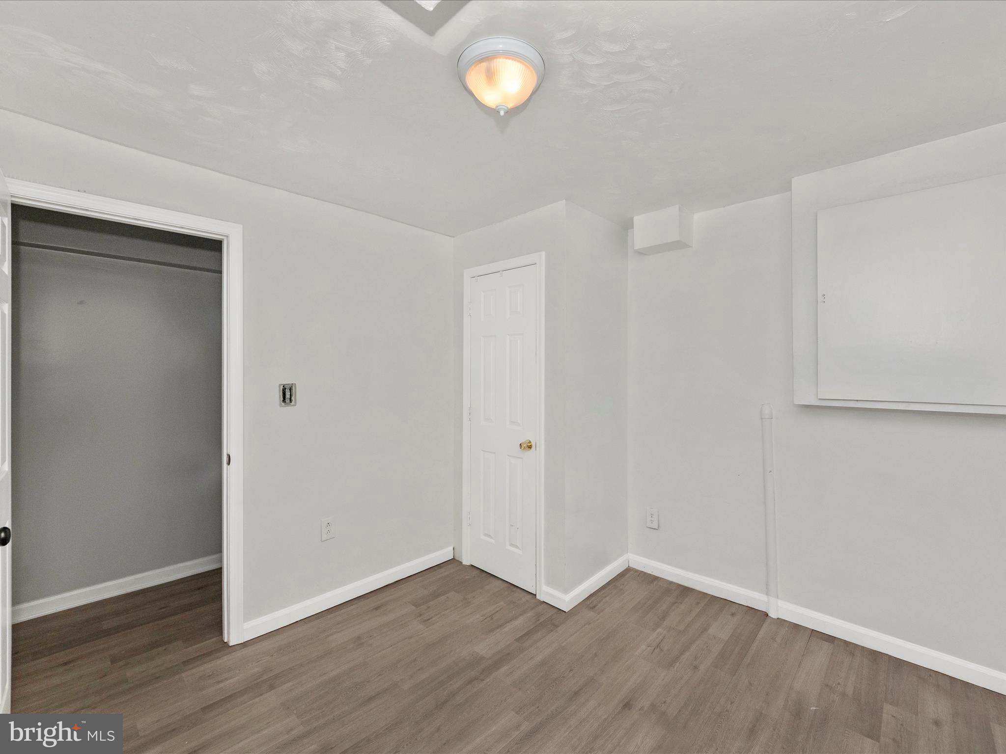 6503 Walker Branch Drive Laurel, MD 20707 - Photo 29 of 36 a view of an empty room with wooden floor and a window