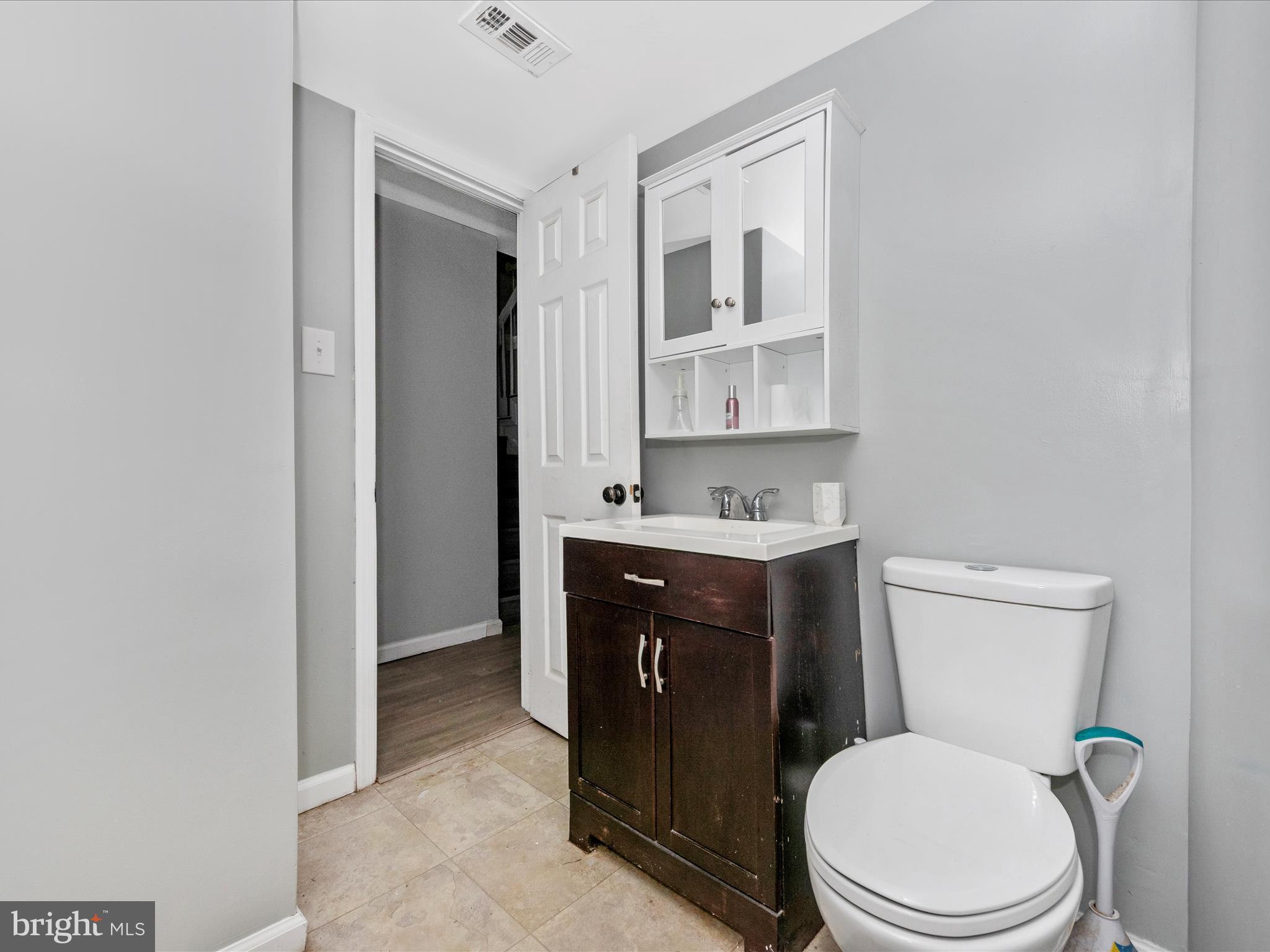 6503 Walker Branch Drive Laurel, MD 20707 - Photo 31 of 36 a white toilet sitting next to a bathroom sink