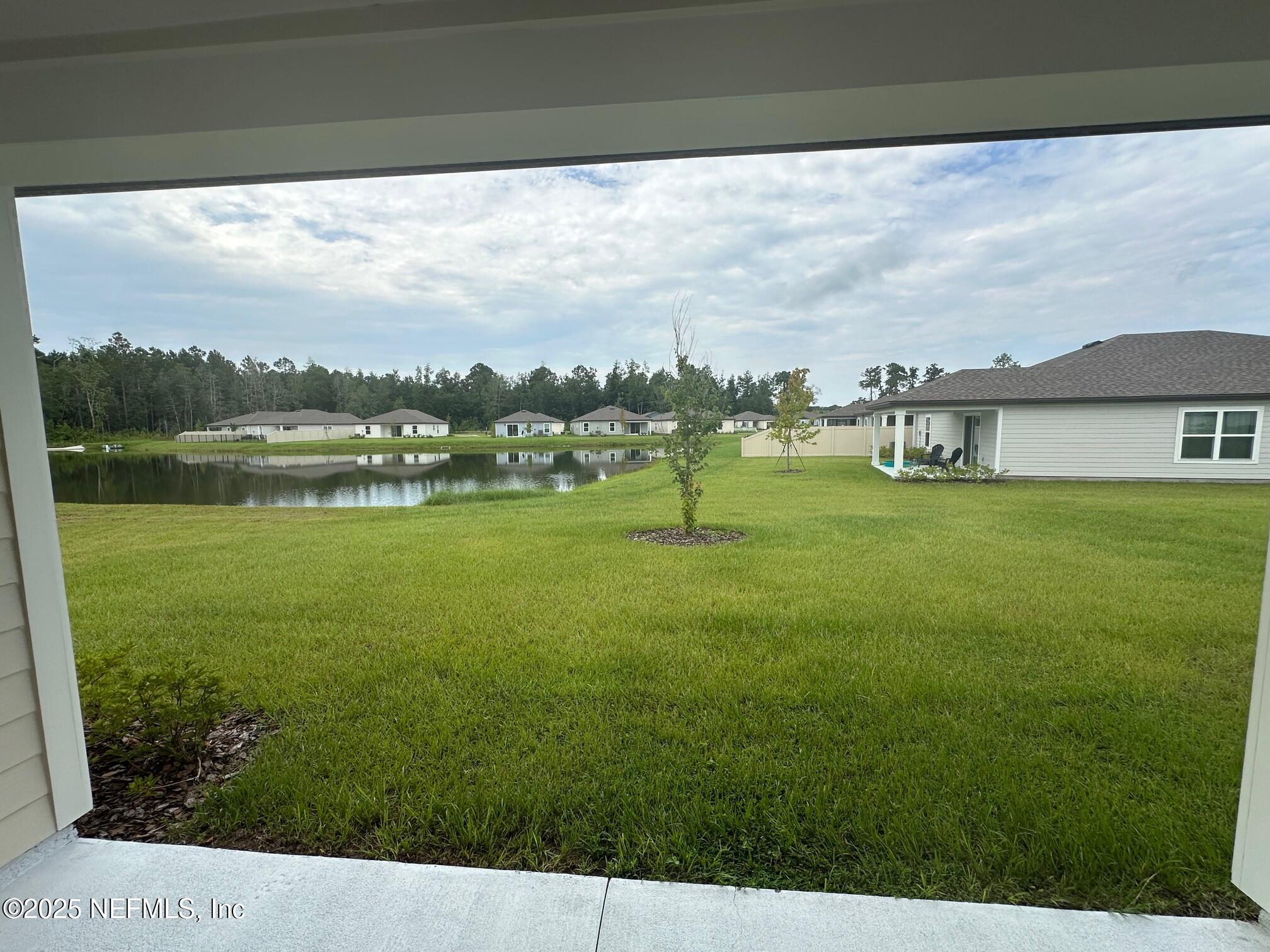 37397 Whisper Way Hilliard, FL 32046 - Photo 12 of 14 a view of a lake with a big yard