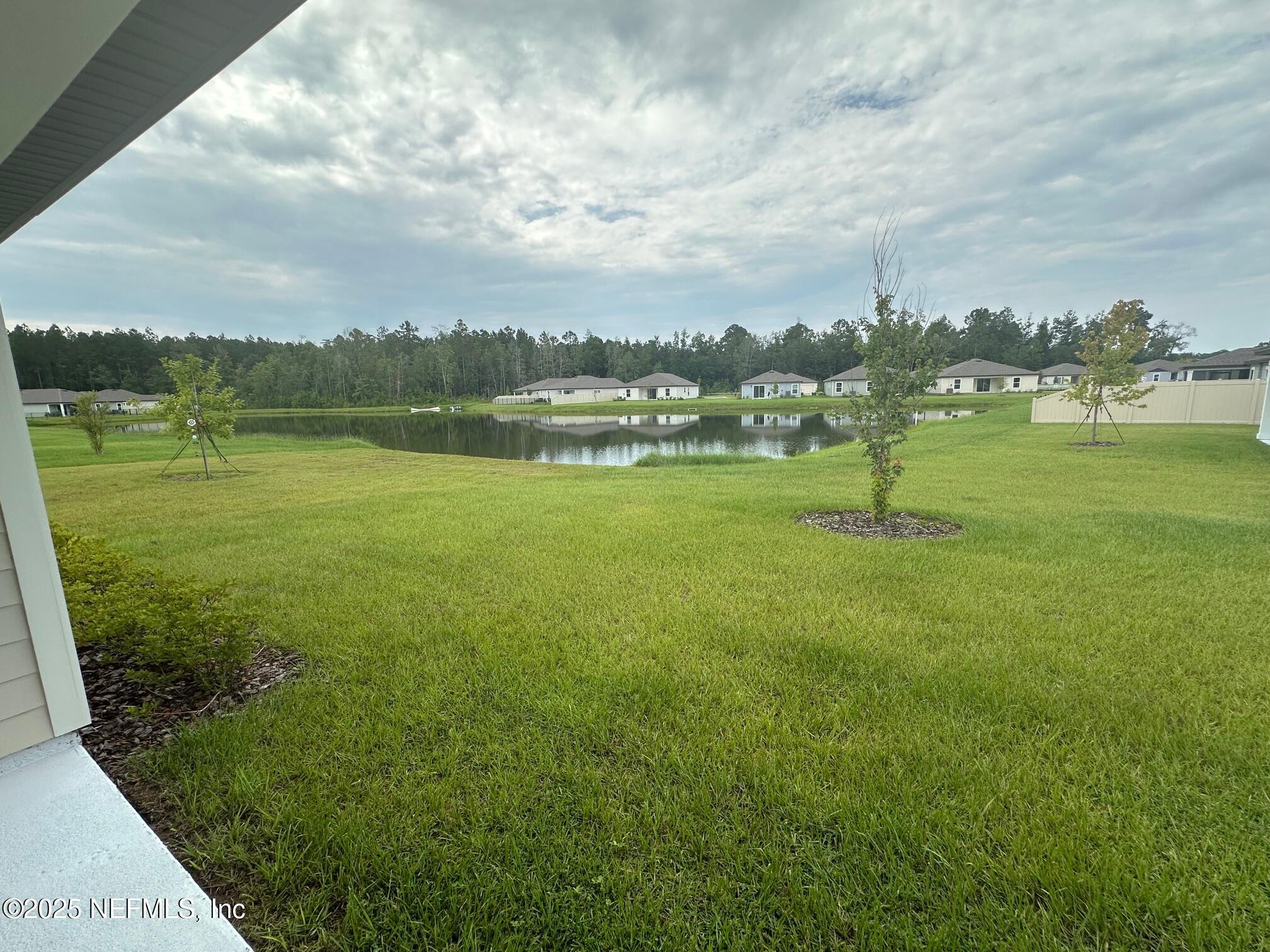 37397 Whisper Way Hilliard, FL 32046 - Photo 13 of 14 a view of a lake with houses in the back