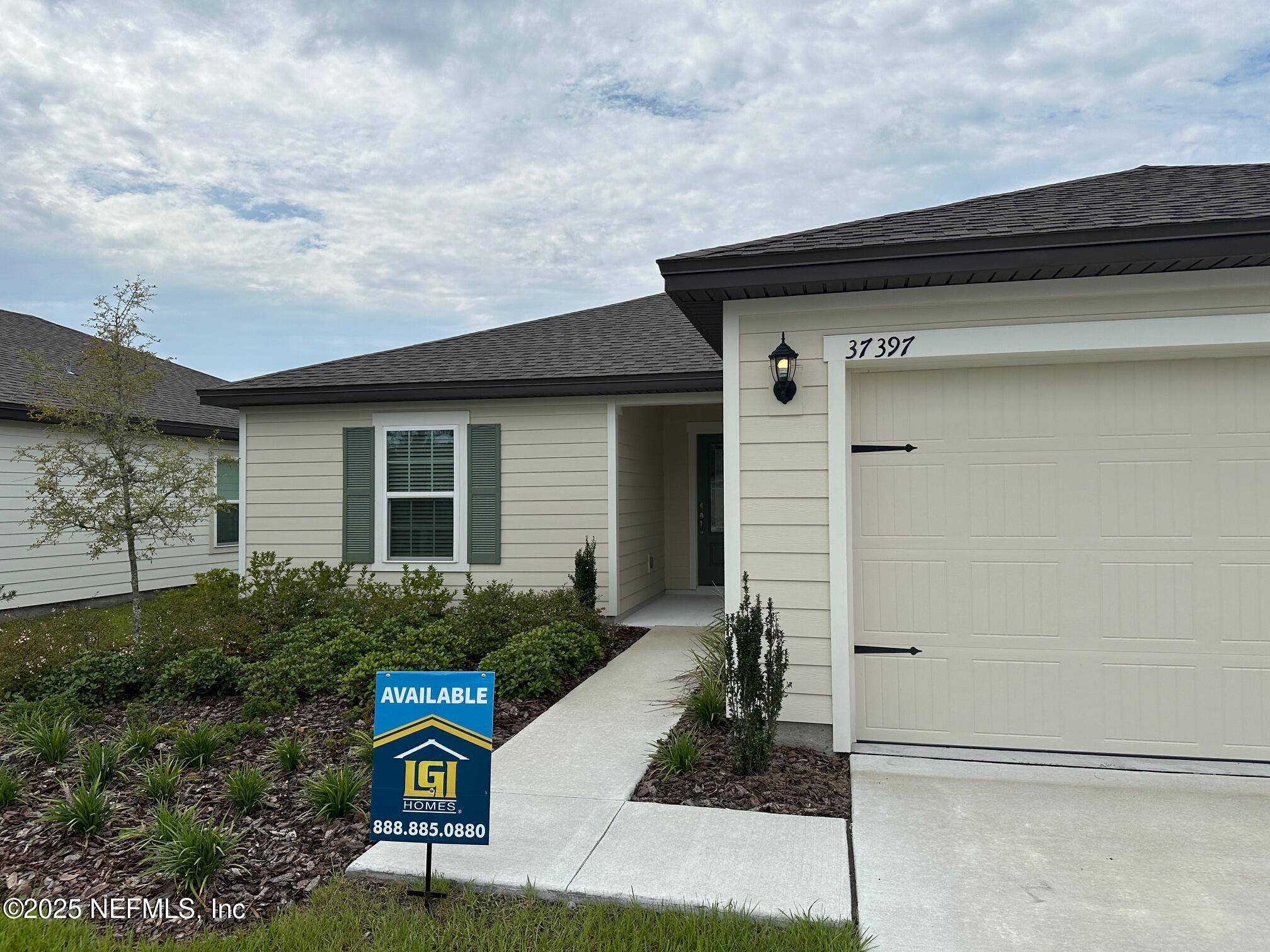 37397 Whisper Way Hilliard, FL 32046 - Photo 2 of 14 a front view of a house with garden