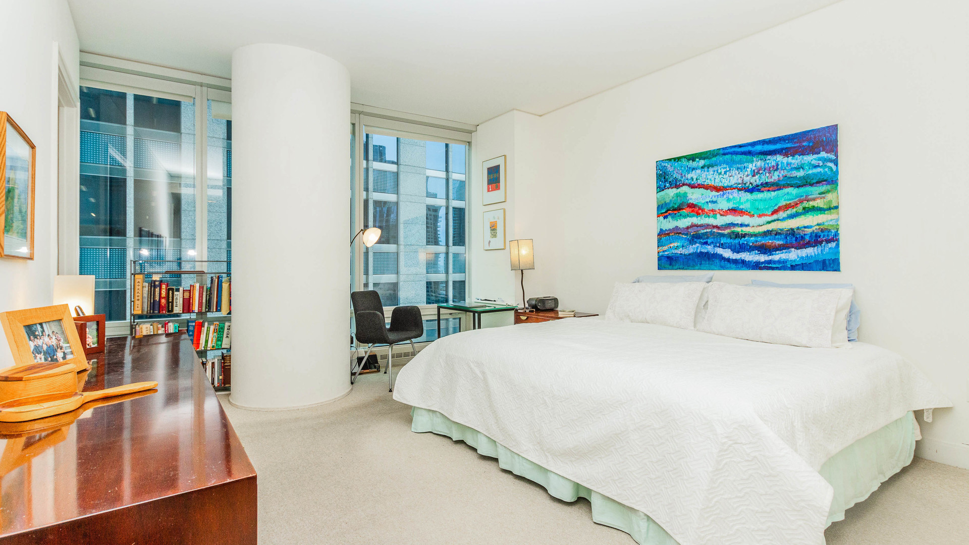 340 East Randolph Street, Unit 1106 Chicago, IL 60601 - Photo 11 of 19 a bedroom with a bed a painting and a lamp