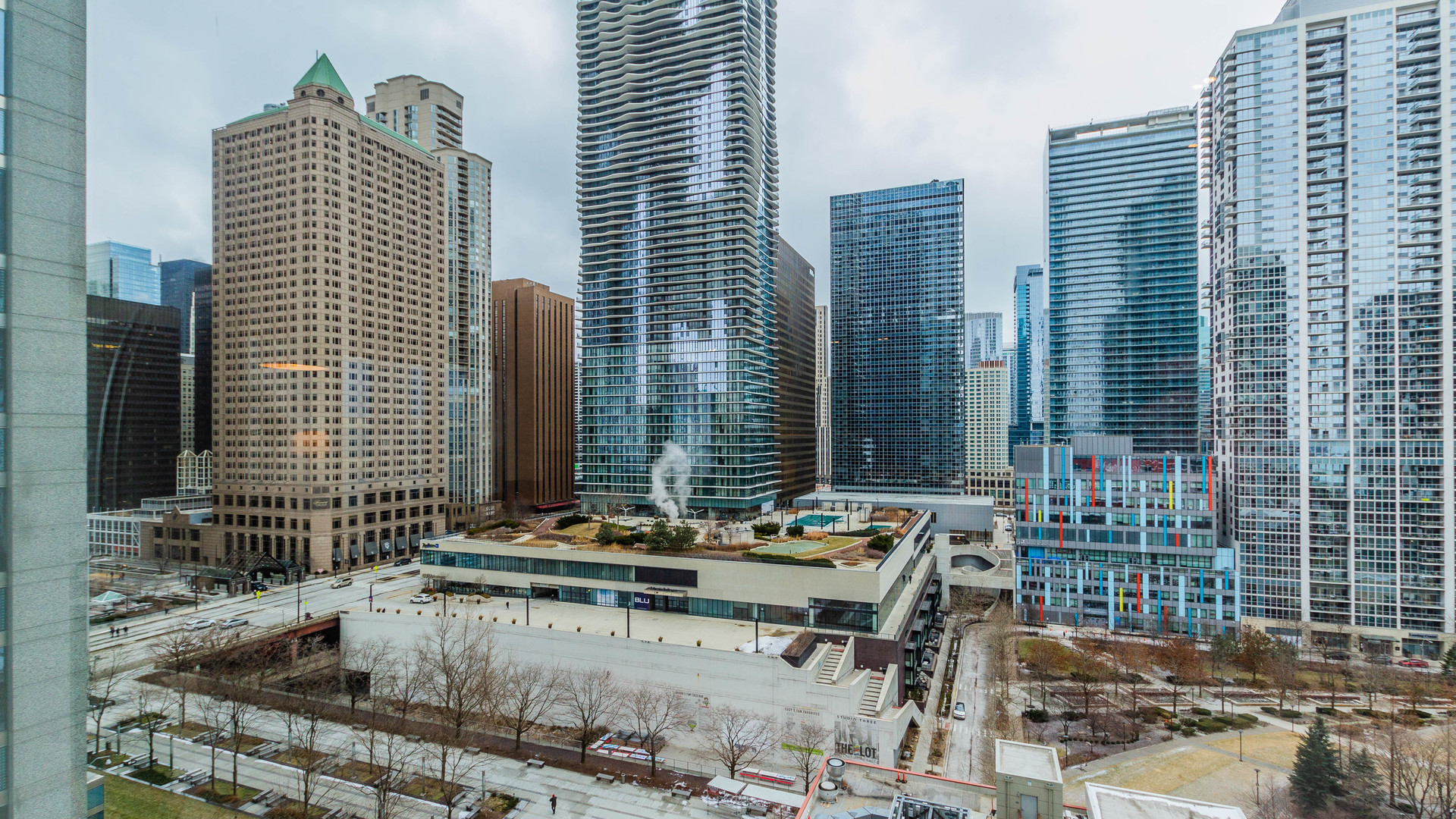 340 East Randolph Street, Unit 1106 Chicago, IL 60601 - Photo 16 of 19 a bathroom with a granite countertop sink and a mirror