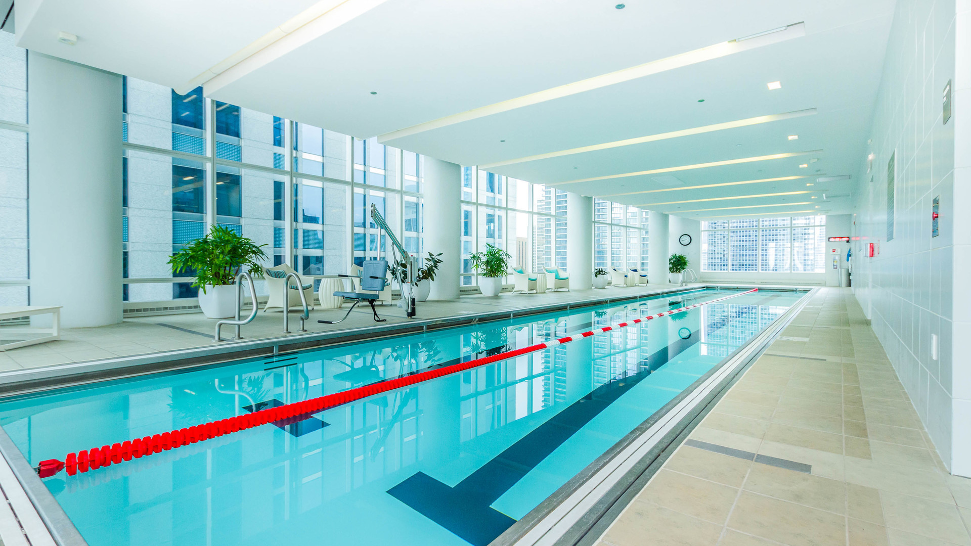 340 East Randolph Street, Unit 1106 Chicago, IL 60601 - Photo 17 of 19 a kitchen with lots of white cabinets and chandelier