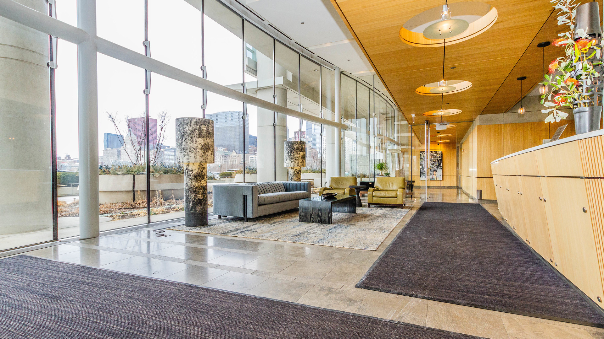 340 East Randolph Street, Unit 1106 Chicago, IL 60601 - Photo 3 of 19 a lobby with furniture and floor to ceiling windows