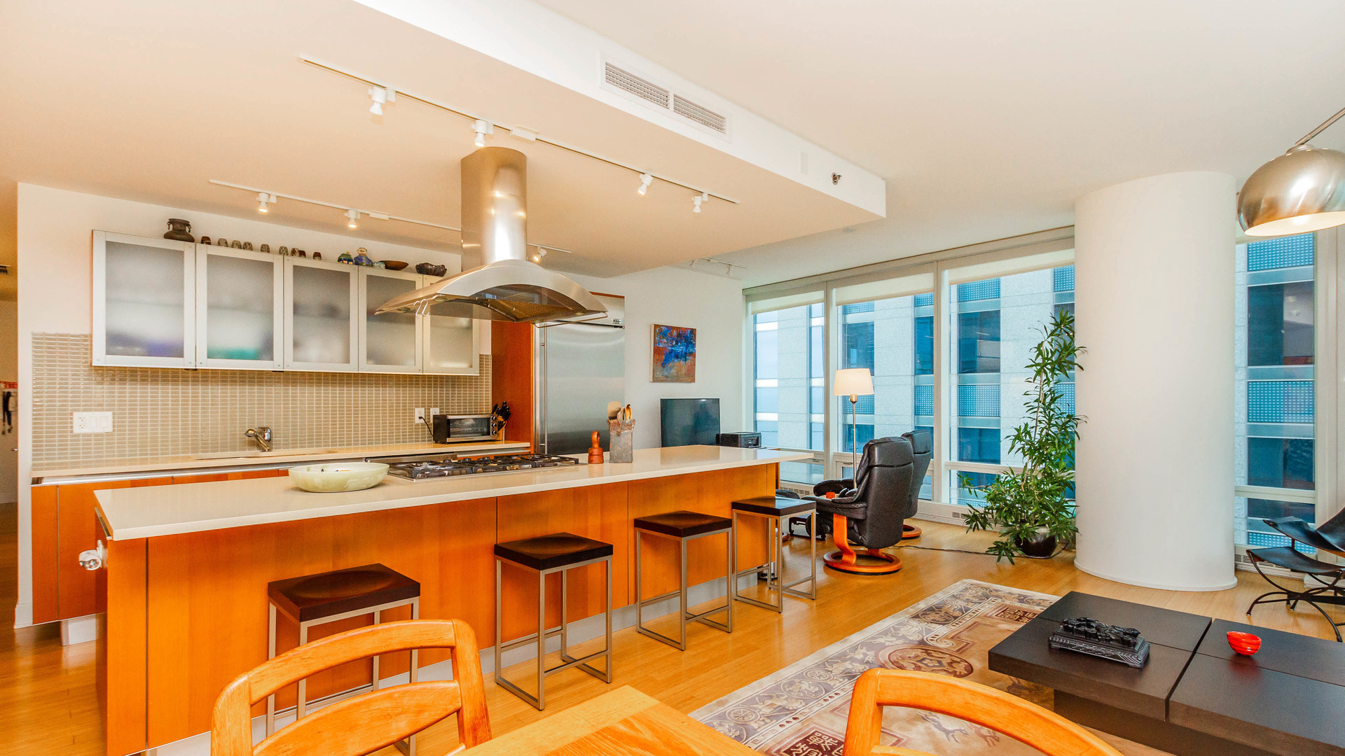 340 East Randolph Street, Unit 1106 Chicago, IL 60601 - Photo 7 of 19 a dining hall with stainless steel appliances granite countertop a dining table and chairs with wooden floor