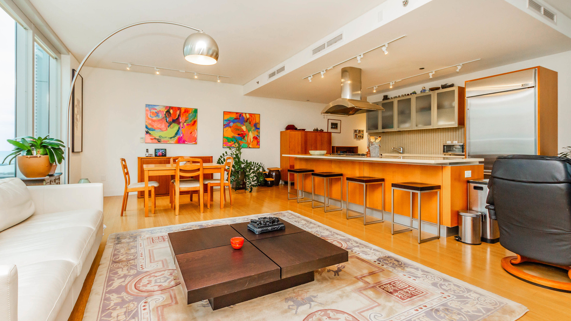 340 East Randolph Street, Unit 1106 Chicago, IL 60601 - Photo 9 of 19 a living room with dining room and wooden floor