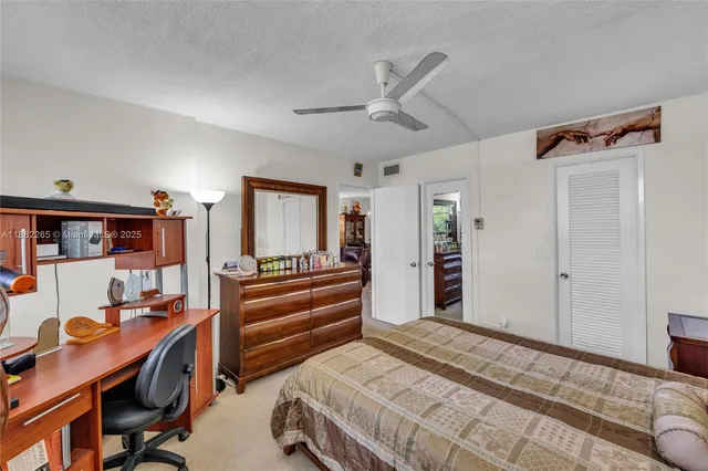 a bedroom with a bed and a desk